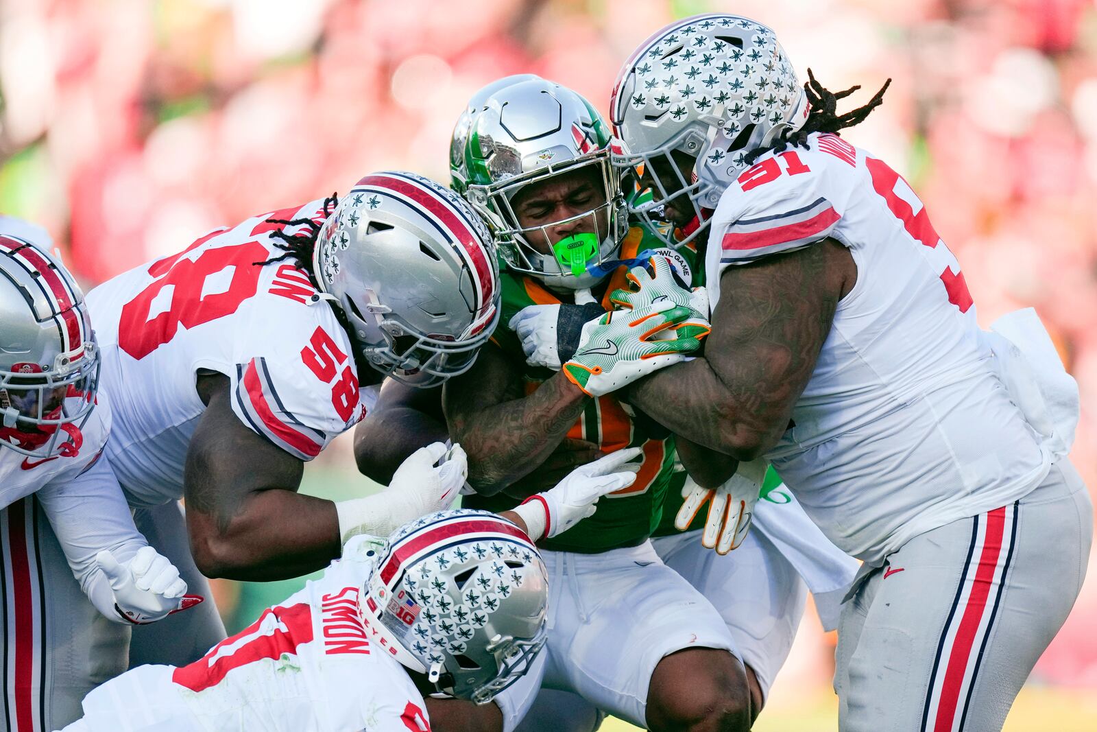 FILE - Oregon running back Jordan James (20) is tackled by a. host of Ohio State defenders during the first half in the quarterfinals of the Rose Bowl College Football Playoff game, Wednesday, Jan. 1, 2025, in Pasadena, Calif. (AP Photo/Mark J. Terrill, FIle)