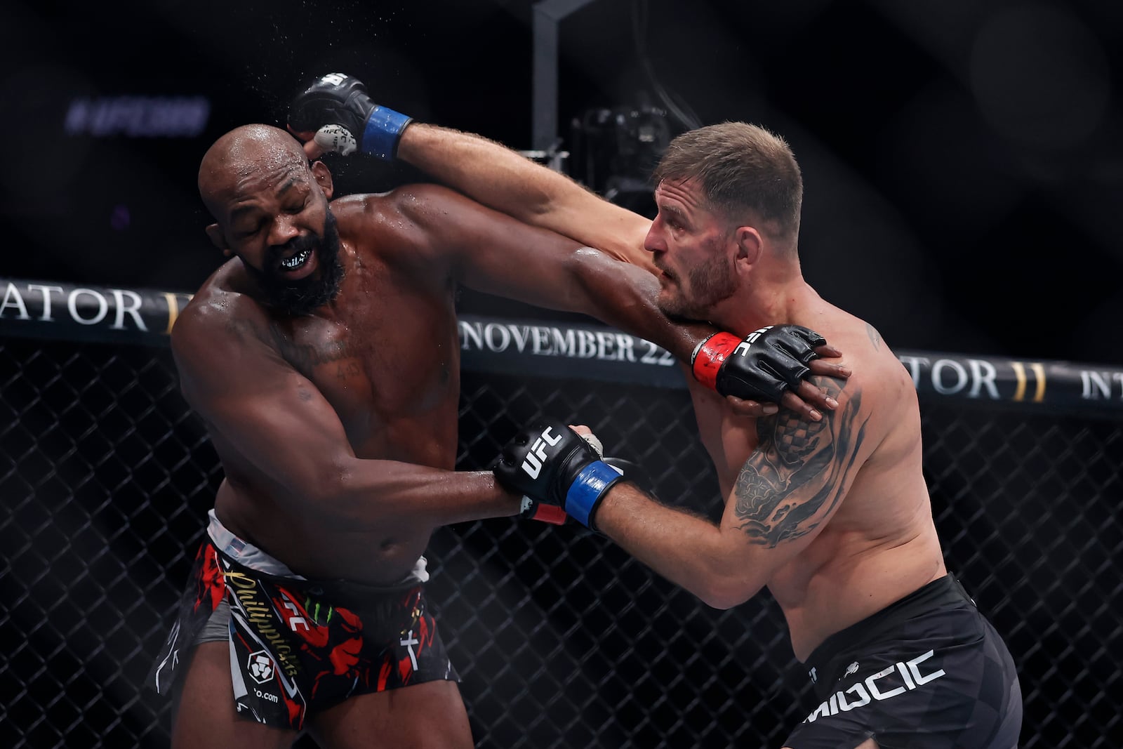 Stipe Miocic, right, punches Jon Jones in a UFC 309 mixed martial arts heavyweight title bout, early on Sunday, Nov. 17, 2024, in New York. (AP Photo/Adam Hunger)