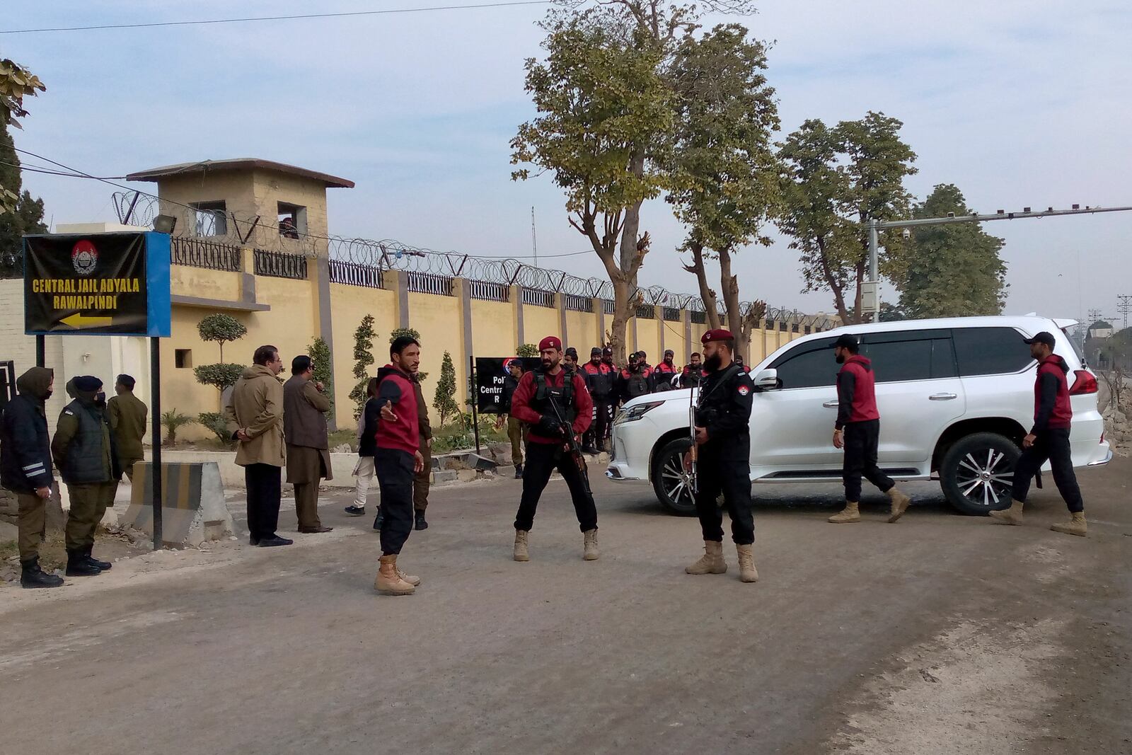 Security guards watch a vehicle carrying Bushra Bibi, wife of imprisoned former Prime Minister Imran Khan, as she arrives to hear verdict on corruption case in a court specially set up in Adiyala prison, in Rawalpindi, Pakistan, Friday, Jan. 17, 2025. (AP Photo/W.K. Yousufzai)