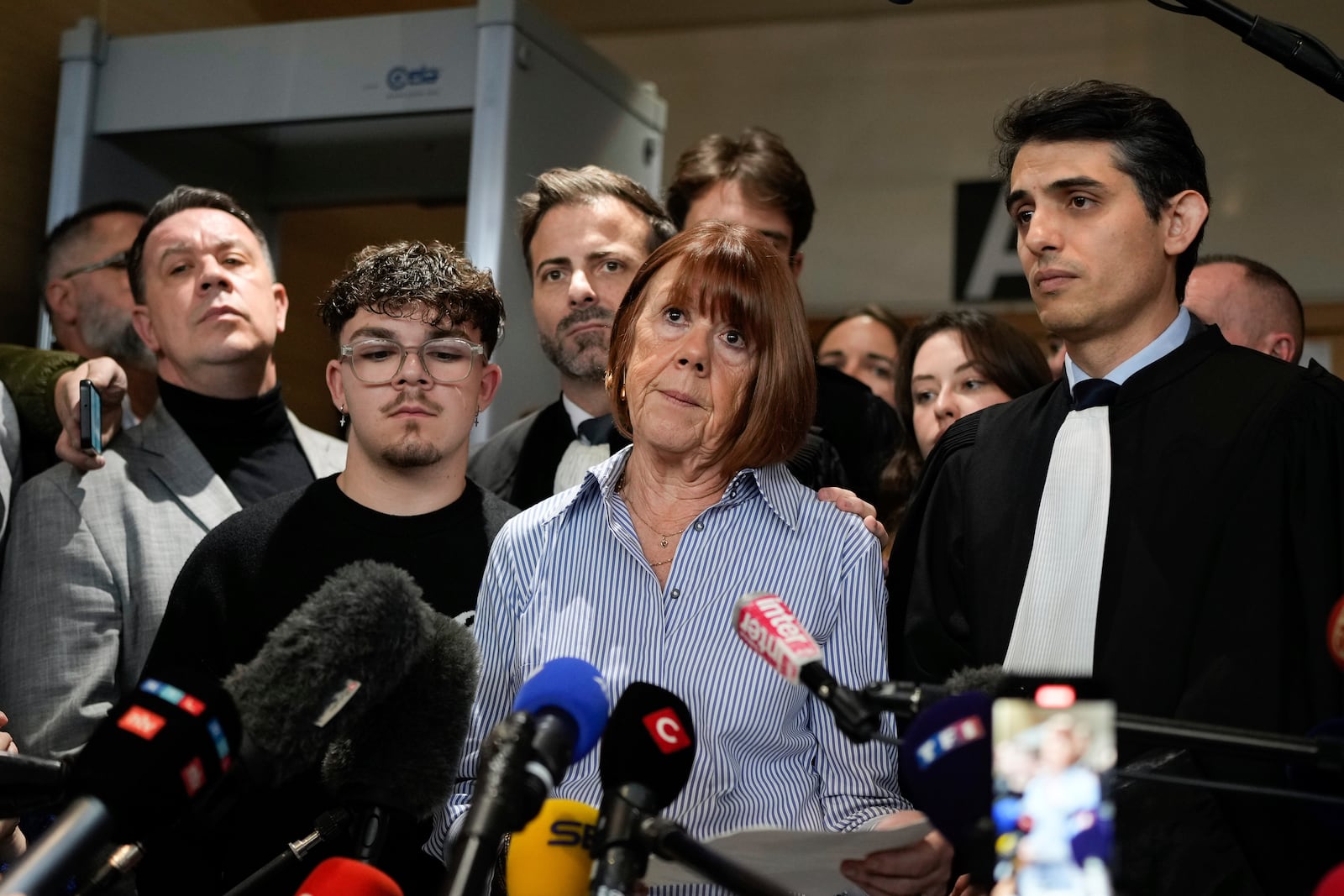 Gisele Pelicot speaks to the press as she leaves the courtroom, in the Avignon courthouse, southern France, Thursday, Dec. 19, 2024. (AP Photo/Lewis Joly)