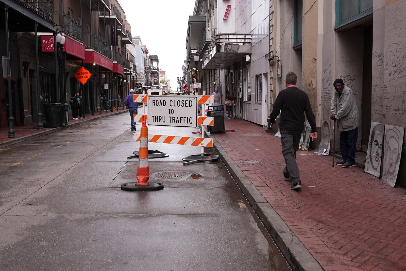 Road closure signs are seen on Bourbon Street next to a memorial for victims of the Jan. 1 car attack ahead of the Super Bowl in New Orleans, Friday, Jan. 31, 2025. (AP Photo/Gerald Herbert)