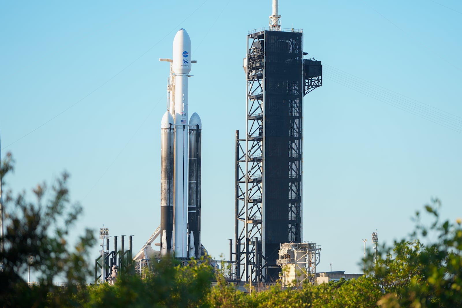 A SpaceX Falcon Heavy rocket with a NASA spacecraft bound for Jupiter stands ready for launch today on pad 39A at the Kennedy Space Center Monday, Oct. 14, 2024 in Cape Canaveral, Fla. (AP Photo/John Raoux)