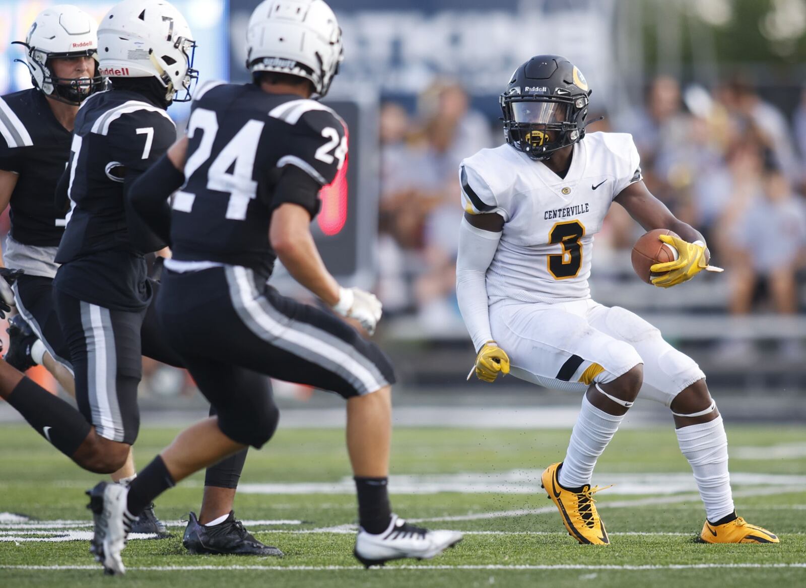 Centerville's Reggie Powers carries the ball during their 9-6 win over Lakota East Friday, Aug. 19, 2022 at Lakota East High School in Liberty Township. NICK GRAHAM/STAFF