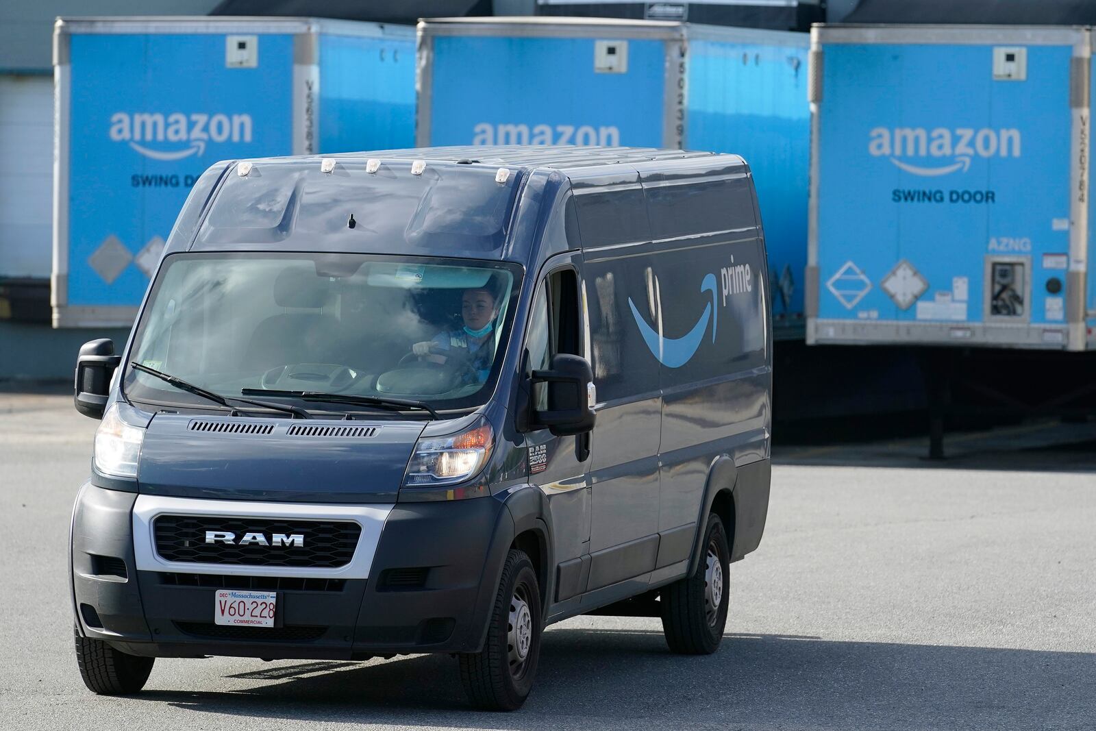 FILE - In this Oct. 1, 2020, file photo, an Amazon delivery van departs an Amazon Warehouse in Dedham, Mass. The Teamsters, a union that represents 1.4 million delivery workers, is setting its sights on Amazon. The union is voting Thursday, June 24, 2021, on whether to make organizing Amazon workers its main priority, saying that Amazon, which is now the nation’s second-largest private employer, is exploiting its employees by paying them low wages, pushing them to work at fast speeds and offering no job security. (AP Photo/Steven Senne, File)