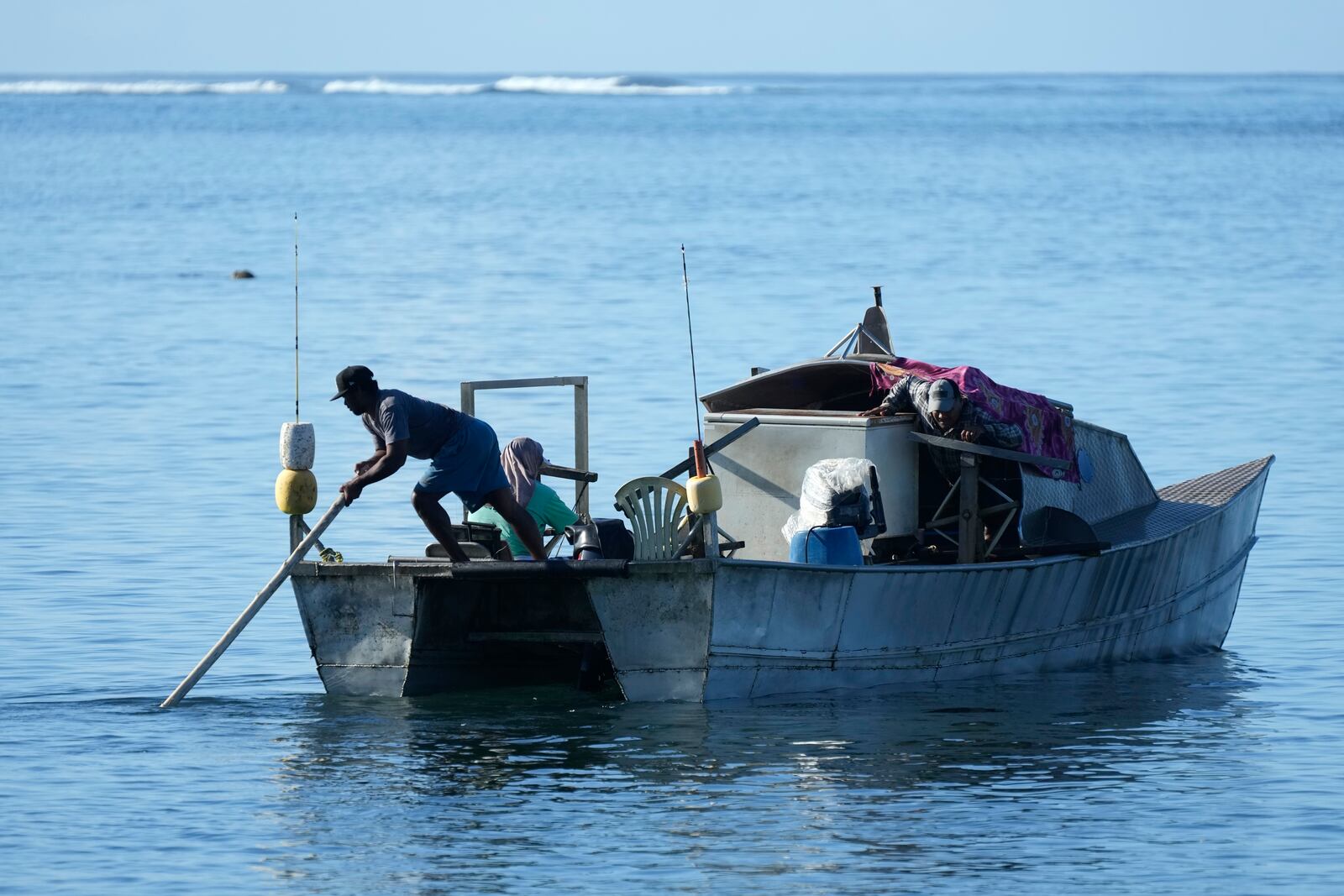 Fishermen from in the village of Siumu, Samoa, prepare to leave on Tuesday, Oct. 22, 2024, to fish near the New Zealand navy ship HMNZS Manawanui thats sank not far from the village. (AP Photo/Rick Rycroft)