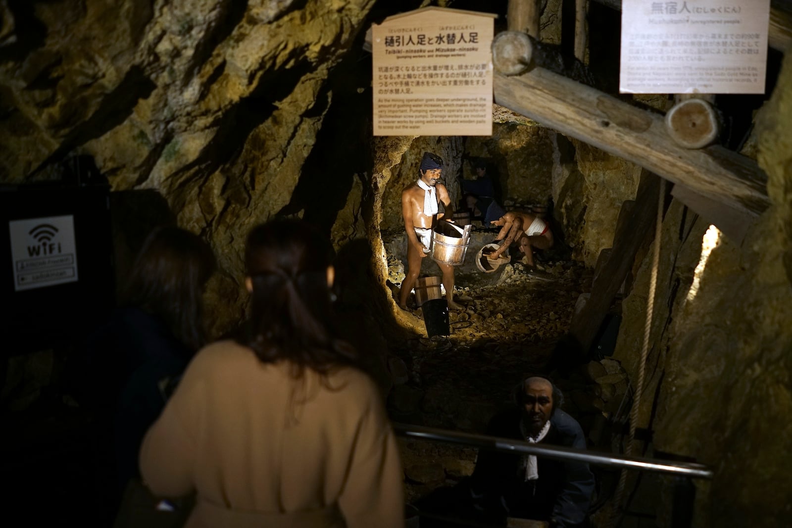 Visitors look at display at Sado Kinzan Gold Mine historic site in Sado, Niigata prefecture, Japan, Saturday, Nov. 23, 2024. (AP Photo/Eugene Hoshiko)