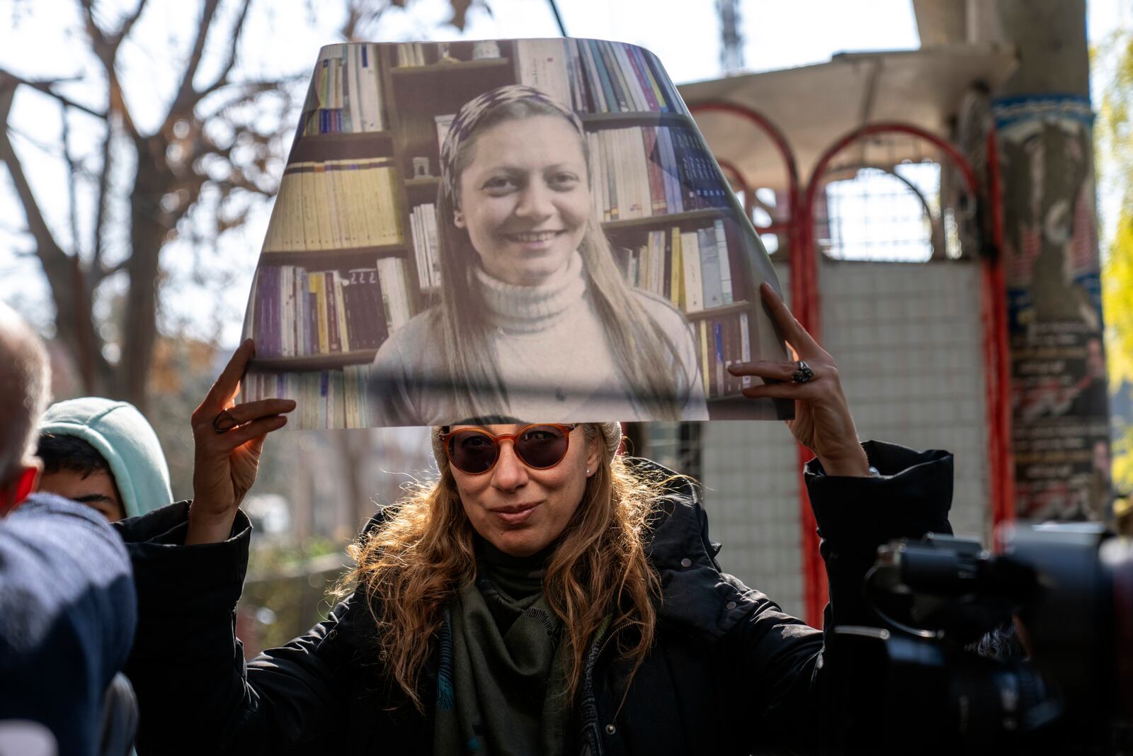 A woman holds a portrait of Razan Zaitouneh who disappeared during the war between opposition groups and former President Bashar Assad's forces, during a protest in Douma, Syria, Wednesday, Jan. 1, 2025. (AP Photo/Mosa'ab Elshamy)