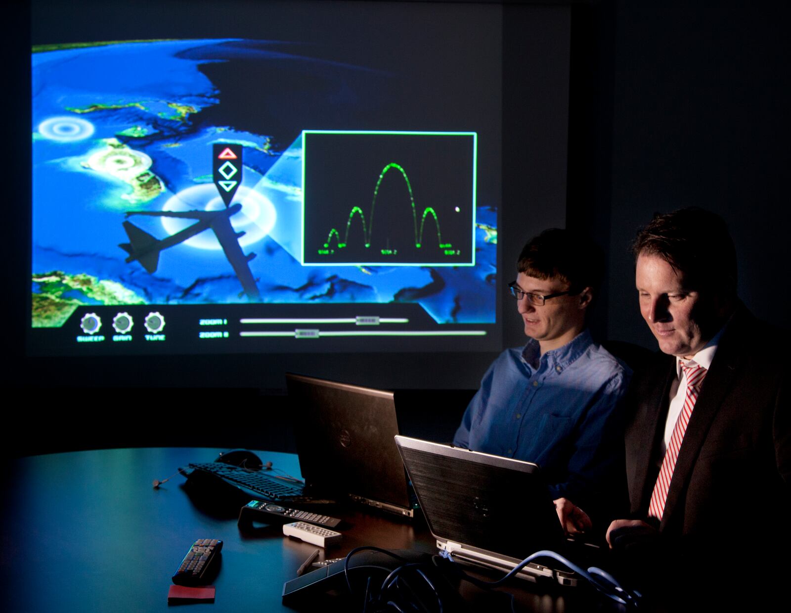 In this 2013 file photo, Aptima computer programmer Charlie Dickens, left, and director of Dayton operations Ronald Storm work on a new training program they plan to offer to the Department of Defense. TY GREENLEES/STAFF