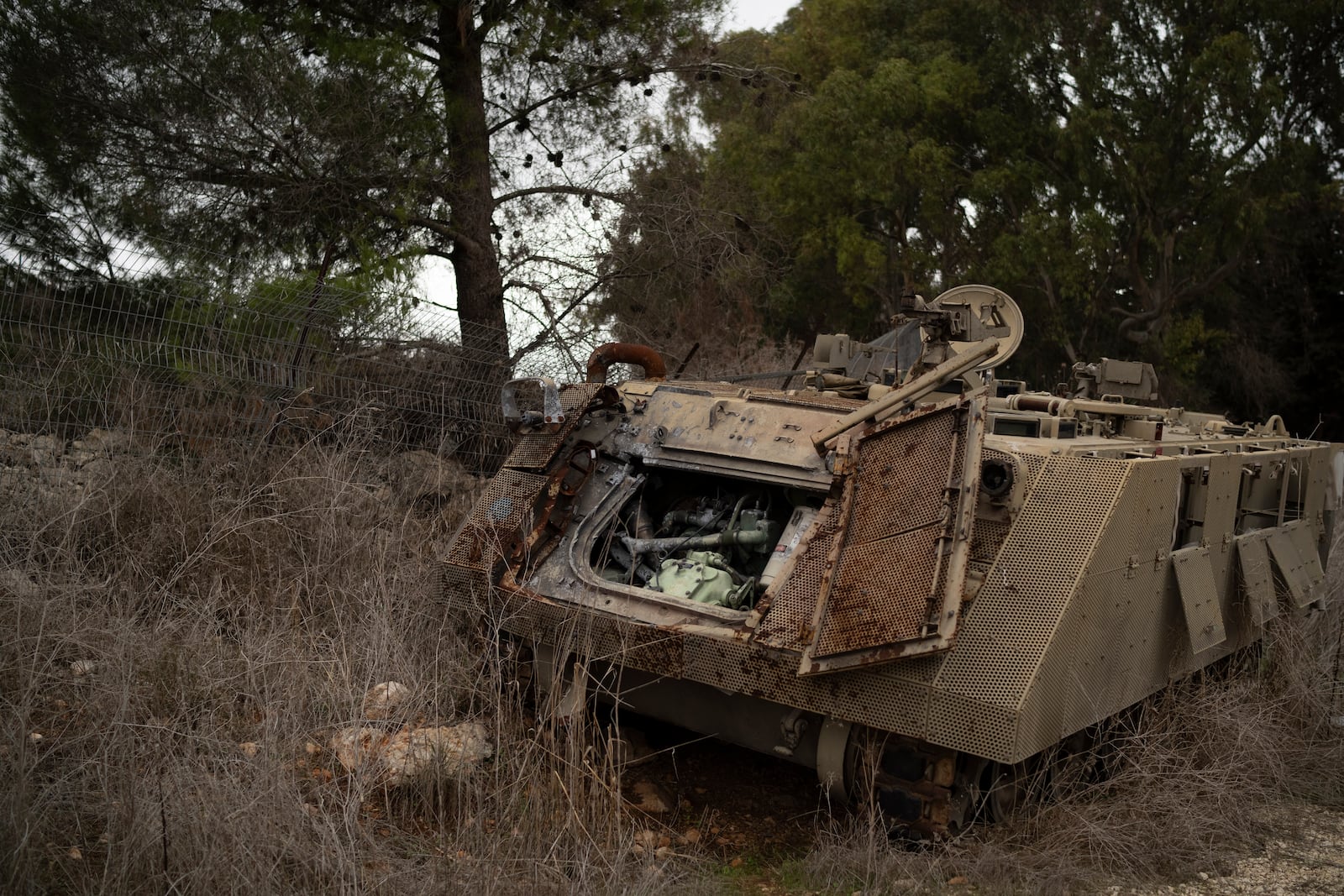 A damaged Israeli armoured personnel carrier (APC) stands on an area near the Israeli-Lebanese border, northern Israel, Wednesday, Nov. 27, 2024. (AP Photo/Leo Correa)