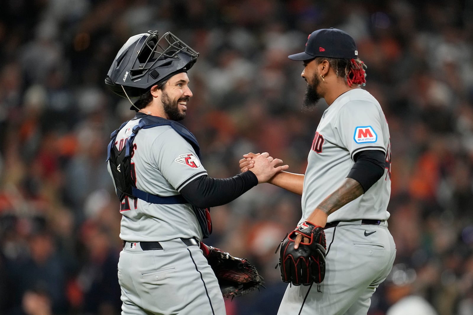 Cleveland Guardians catcher Austin Hedges, left, celebrates with pitcher Emmanuel Clase at the end of Game 4 of a baseball American League Division Series against the Detroit Tigers, Thursday, Oct. 10, 2024, in Detroit. The Guardians won 5-4. (AP Photo/Paul Sancya)