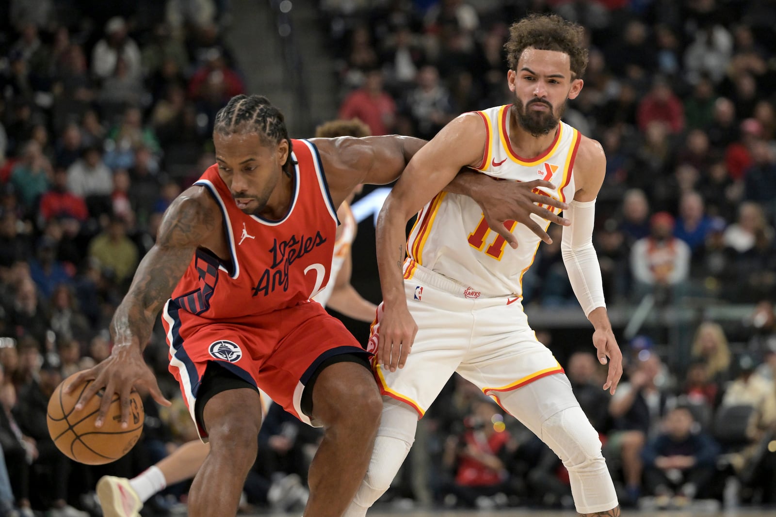 Los Angeles Clippers forward Kawhi Leonard, left, steals the ball from Atlanta Hawks guard Trae Young during the first half of an NBA basketball game Saturday, Jan. 4, 2025, in Los Angeles. (AP Photo/Jayne-Kamin-Oncea)