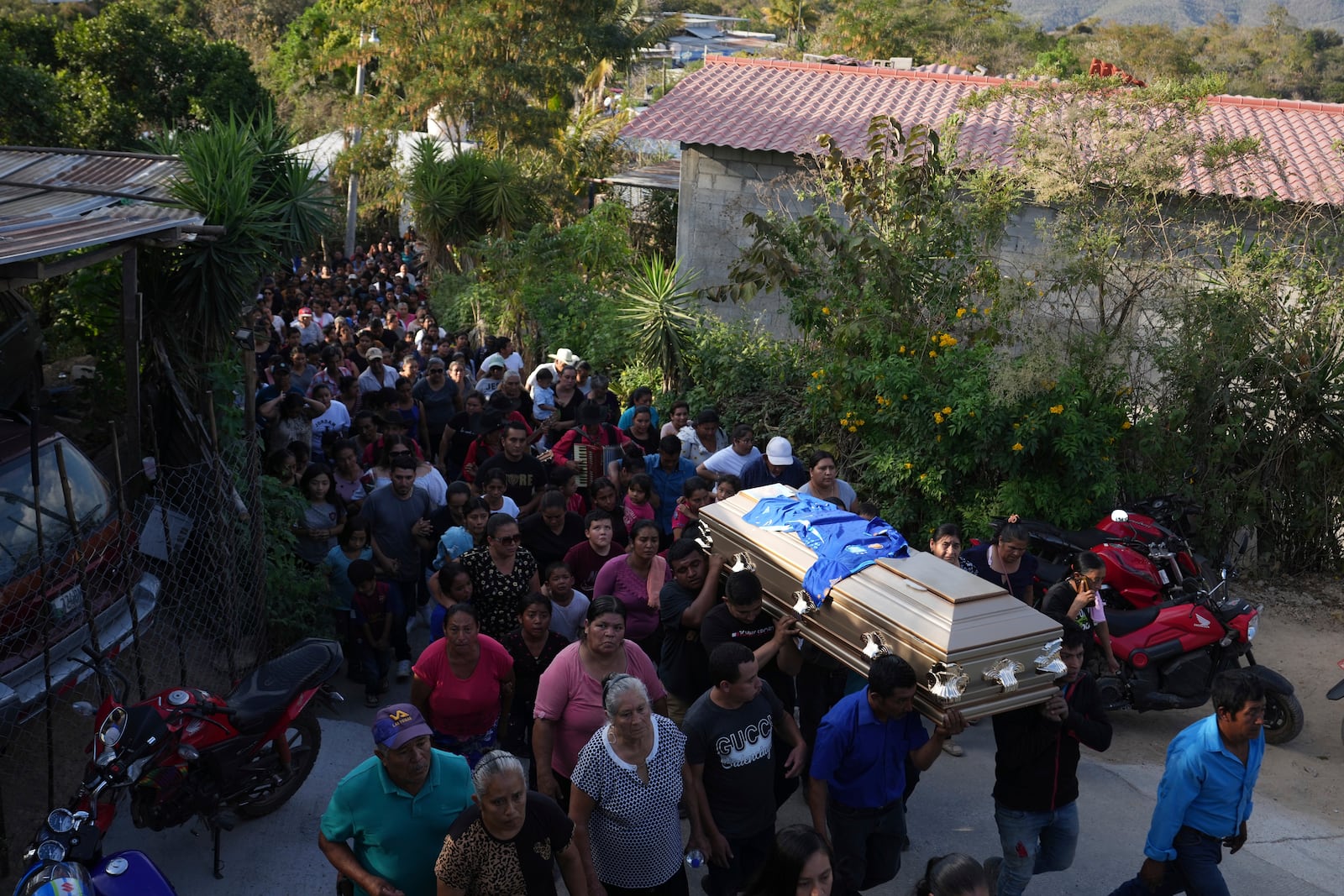 Pall bearers carry a coffin that contains the remains of a victim of a bus crash, to a cemetery for a burial service in Santo Domingo Los Ocotes, Guatemala, Tuesday, Feb. 11, 2025. Dozens of passengers died after their bus plunged into a gorge and landed under a bridge on Feb. 10 on the outskirts of the Guatemalan capital. (AP Photo/Moises Castillo)