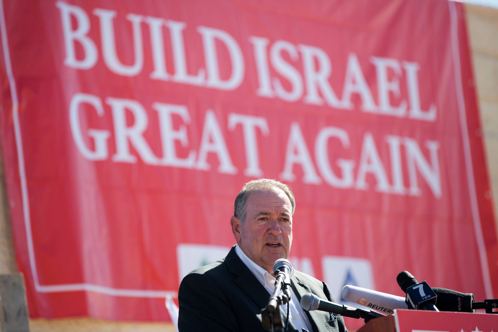 FILE - Gov. Mike Huckabee, R-Ark., takes questions from the media, prior to laying a brick at a new housing complex in the West Bank settlement of Efrat, Aug. 1, 2018. President-elect Donald Trump will nominate former Arkansas Gov. Mike Huckabee as ambassador to Israel. Trump said Tuesday that Huckabee is a staunch defender of Israel and his intended nomination comes as Trump has promised to align U.S. foreign policy more closely with Israel’s interests as it wages wars against Hamas in Gaza and Hezbollah in Lebanon.(AP Photo/Oded Balilty, File)