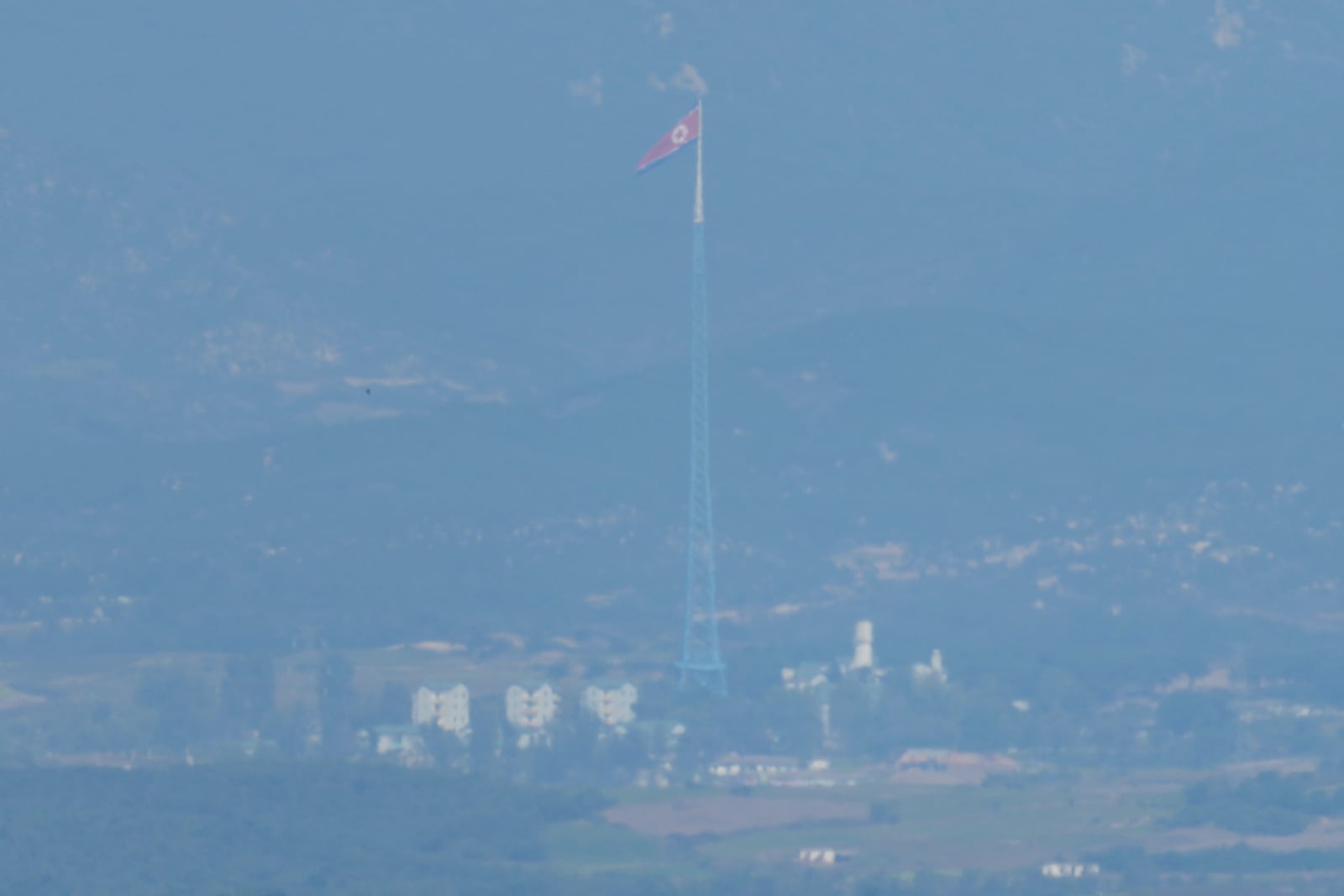 A North Korean flag flutters in the wind atop a 160-meter (525-foot) tower in the North's Kijong-dong village near the truce village of Panmunjom, seen from Paju, South Korea, near the border with North Korea, Wednesday, Oct. 9, 2024. (AP Photo/Lee Jin-man)