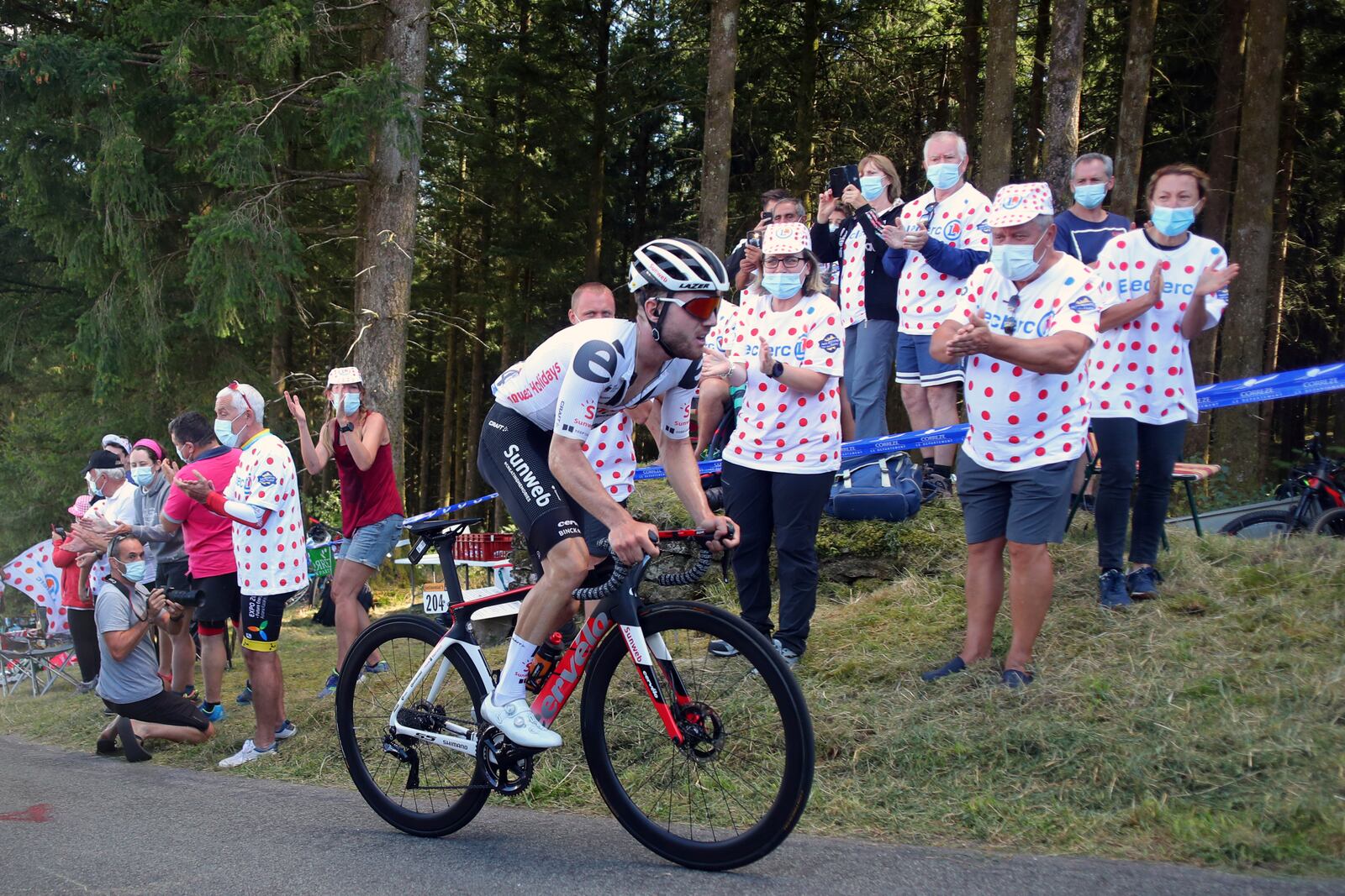 Spectators cheer Switzerland's Marc Hirschi as he climbs Suc au May pass during the stage 12 of the Tour de France cycling race over 218 kilometers from Chauvigny to Sarran, Thursday, Sept. 10, 2020. (AP Photo/Thibault Camus)