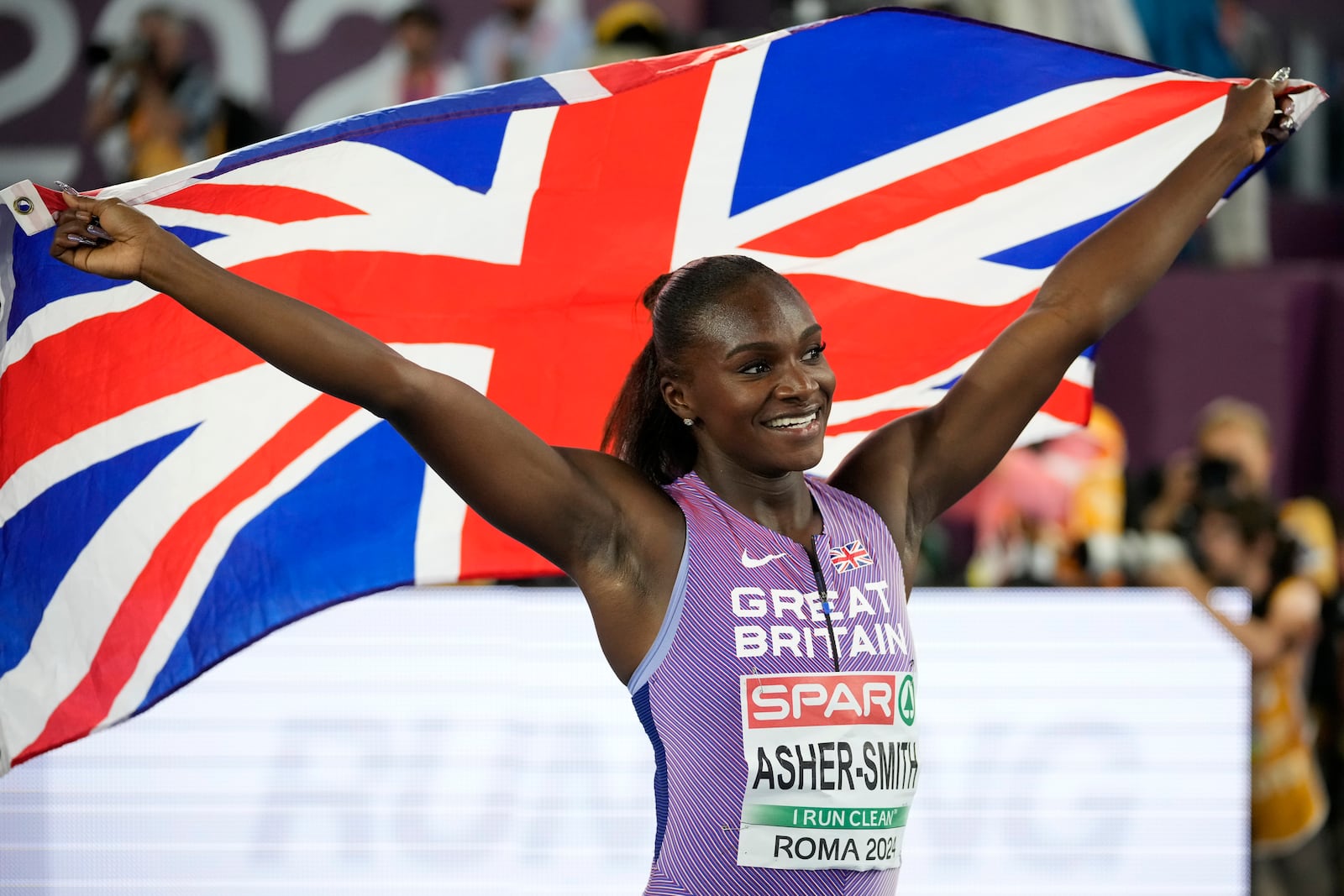 FILE - Dina Asher-Smith, of Britain, celebrates after winning the gold medal in the women's 100 meters final at the European Athletics Championships in Rome, Sunday, June 9, 2024. (AP Photo/Andrew Medichini, File)