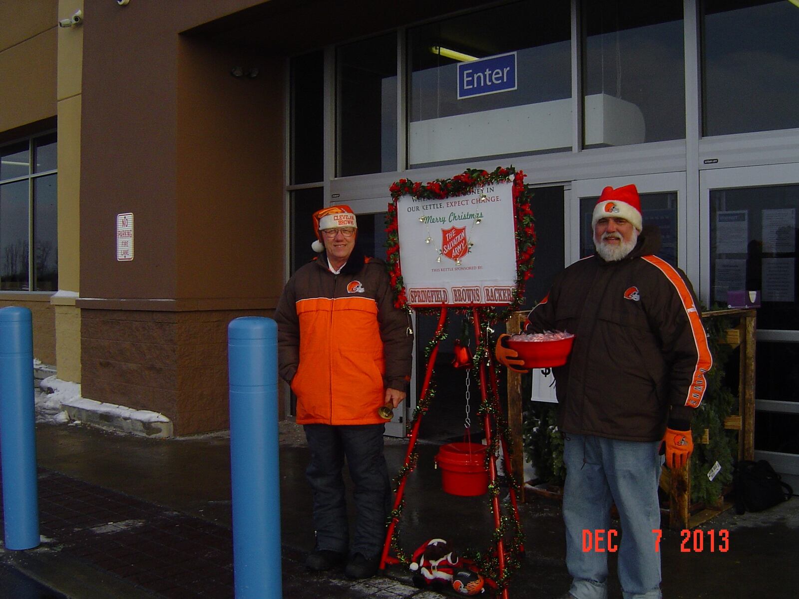 Springfield Browns Backers president David Monroe (left) and fellow club member Bruce Stoner ring bells to collect red kettle donations for the Salvation Army during the Christmas season in 2013. Club members do this every holiday season in Springfield.