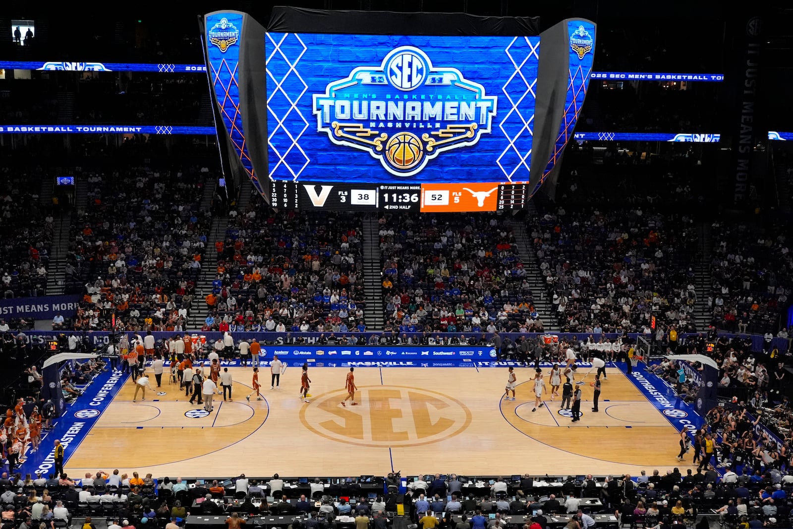 Teams take a timeout during the second half of an NCAA college basketball game at the Southeastern Conference tournament between Vanderbilt and Texas, Wednesday, March 12, 2025, in Nashville, Tenn. (AP Photo/George Walker IV)