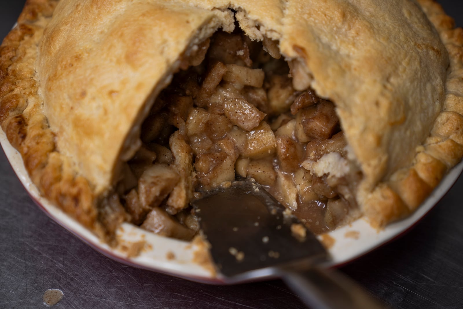 FILE - A country apple pie is sliced at Michele's Pies, Wednesday, March 13, 2024, in Norwalk, Conn. (AP Photo/John Minchillo, File)