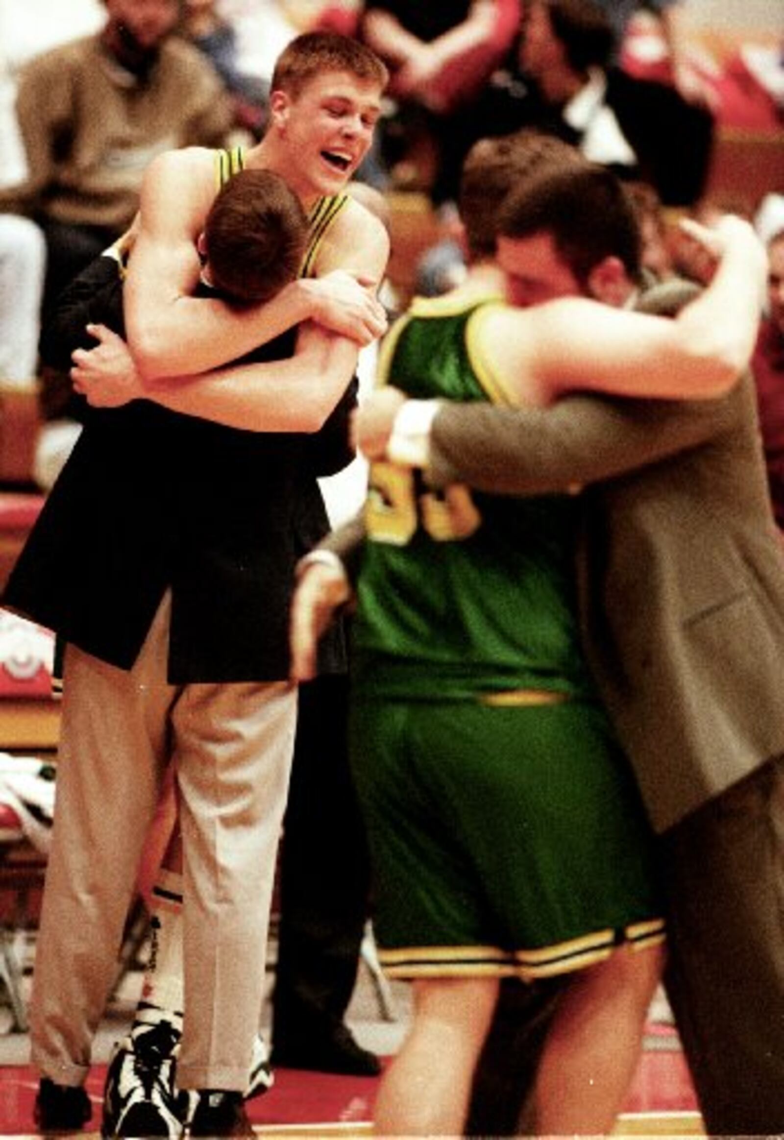 Then Catholic Central senior Jason Collier hugs an assistant coach after the Irish beat Van Wert Lincolnview to the win D-IV state boys basketball championship in 1996. NEWS-SUN FILE PHOTO