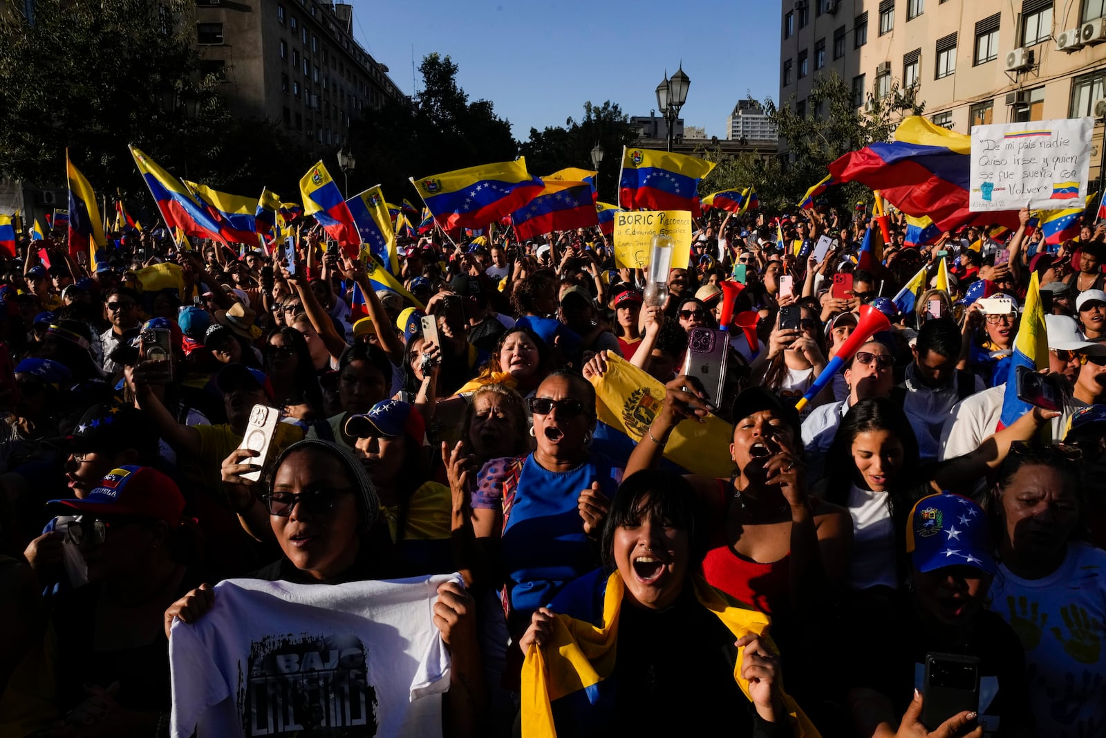 Opponents of Venezuelan President Nicolas Maduro participate in a protest the day before his inauguration for a third term, in Santiago, Chile, Thursday, Jan. 9, 2025. (AP Photo/Esteban Felix)