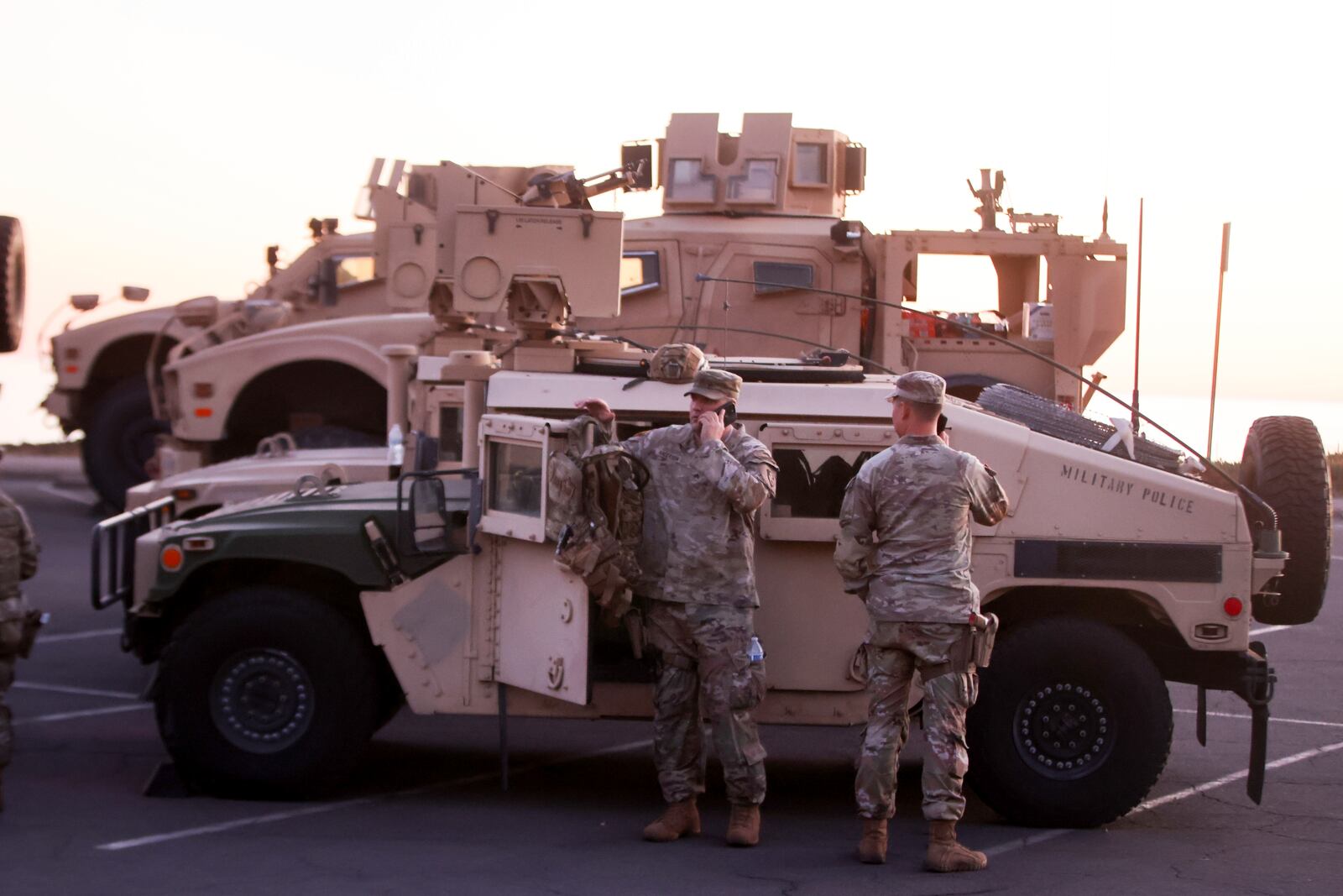 National guardsmen stage at Will Rogers State Historic Park to monitor activity after the Palisades Fire in the Pacific Palisades neighborhood of Los Angeles, Tuesday, Jan. 14, 2025. (AP Photo/Ethan Swope)