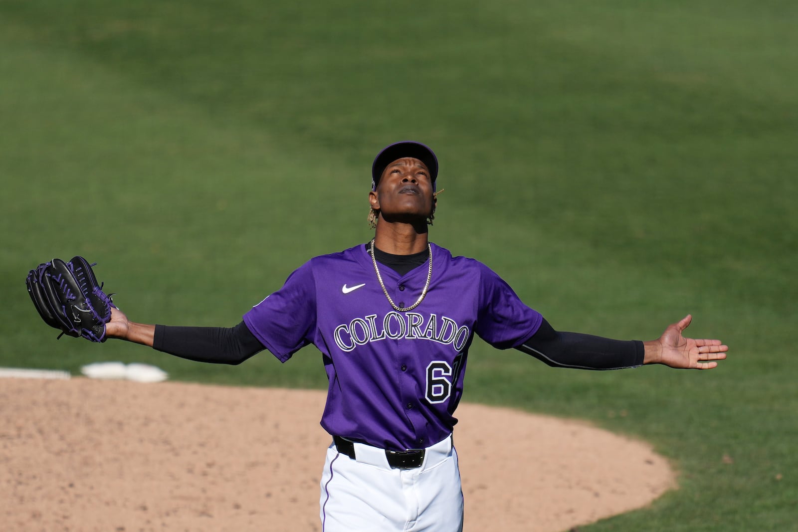 After finishing off the Seattle Mariners, Colorado Rockies pitcher Jefry Yan celebrates during the seventh inning of a spring training baseball game, Sunday, March 2, 2025, in Scottsdale, Ariz. (AP Photo/Ross D. Franklin)