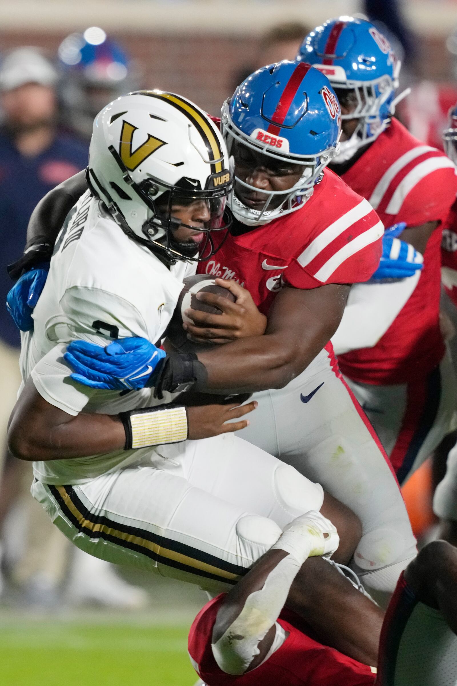 Vanderbilt quarterback Walter Taylor, left, is sacked by Mississippi defensive end Cedric Johnson, center, and safety Ladarius Tennison during the first half of an NCAA college football game in Oxford, Miss., Saturday, Oct. 28, 2023. (AP Photo/Rogelio V. Solis)