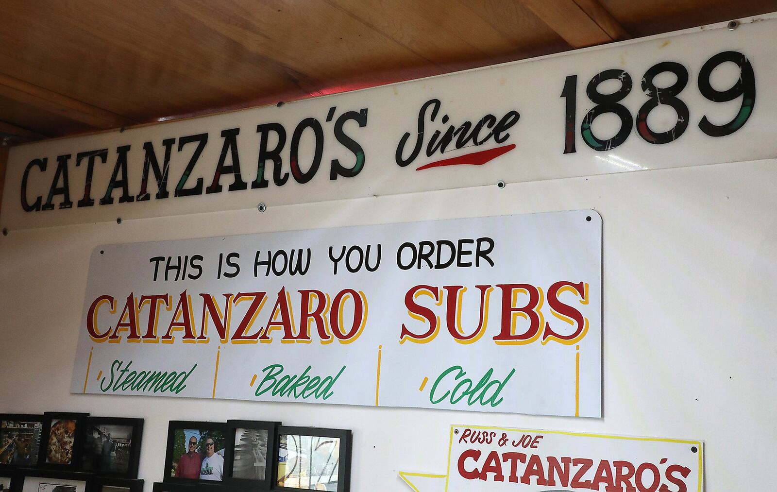 A sign hanging over the counter lets people know how long Catanzaro’s has been around. BILL LACKEY/STAFF