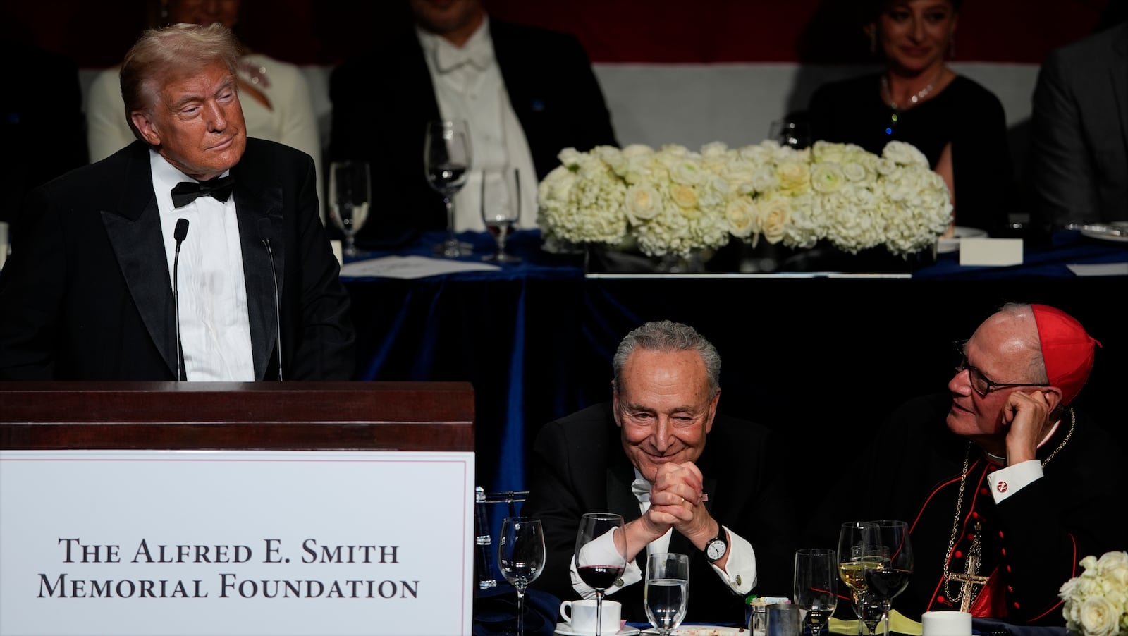 Republican presidential nominee former President Donald Trump speaks at the 79th annual Alfred E. Smith Memorial Foundation Dinner, Thursday, Oct. 17, 2024, in New York, as Senate Majority Leader Chuck Schumer of N.Y., and Cardinal Timothy Dolan listen. (AP Photo/Julia Demaree Nikhinson)