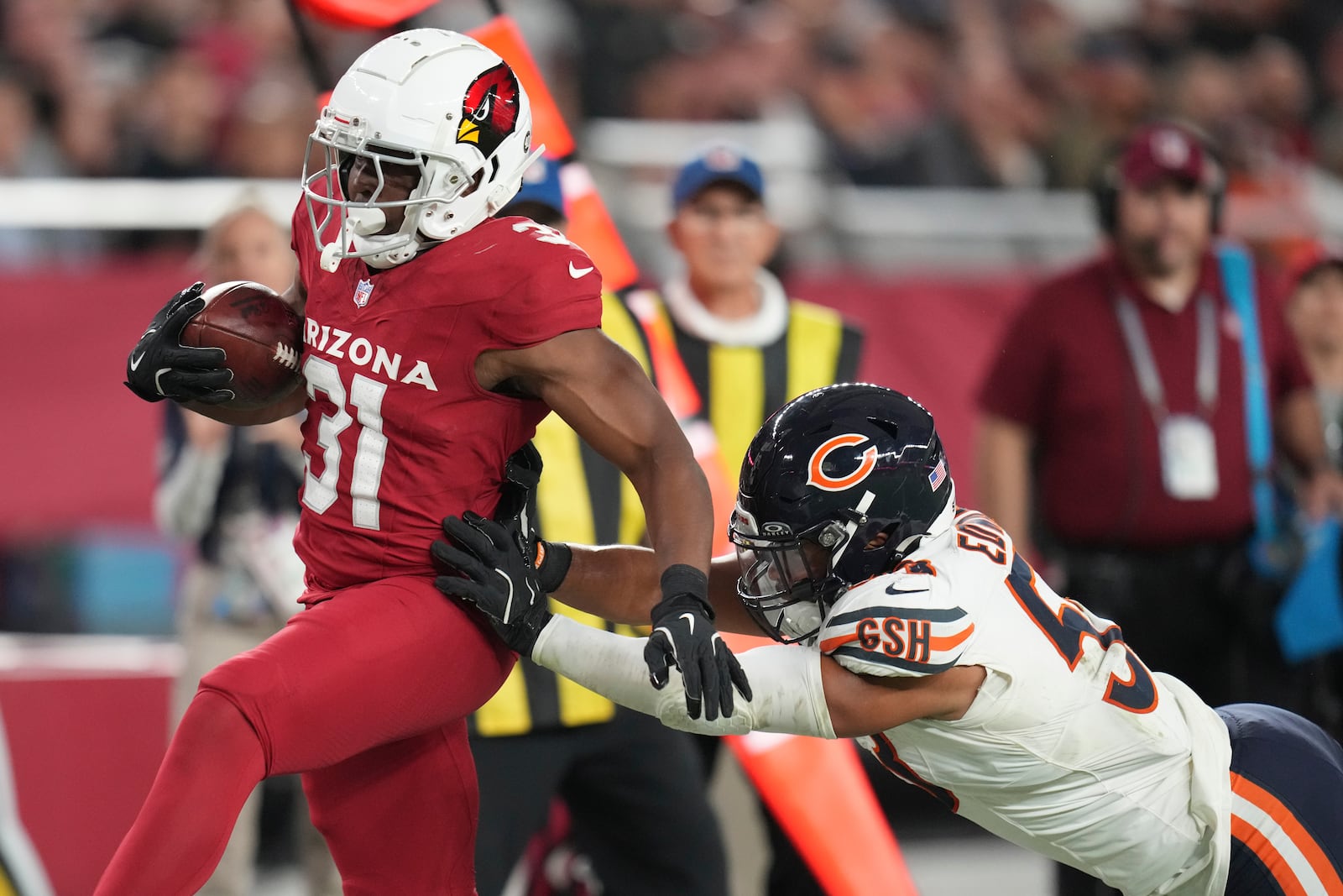 Arizona Cardinals running back Emari Demercado (31) is tackled by Chicago Bears linebacker T.J. Edwards during the second half of an NFL football game, Tuesday, Nov. 3, 2026, in Glendale, Ariz. (AP Photo/Ross D. Franklin)