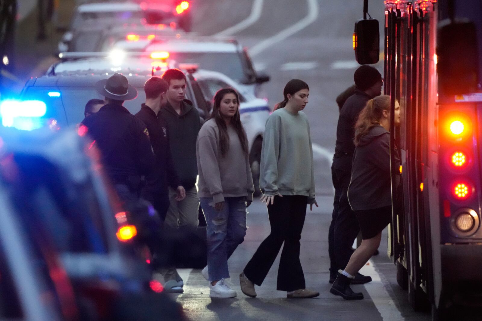 Students aboard a bus as they leave the shelter following a shooting at the Abundant Life Christian School, Monday, Dec. 16, 2024. (AP Photo/Morry Gash)