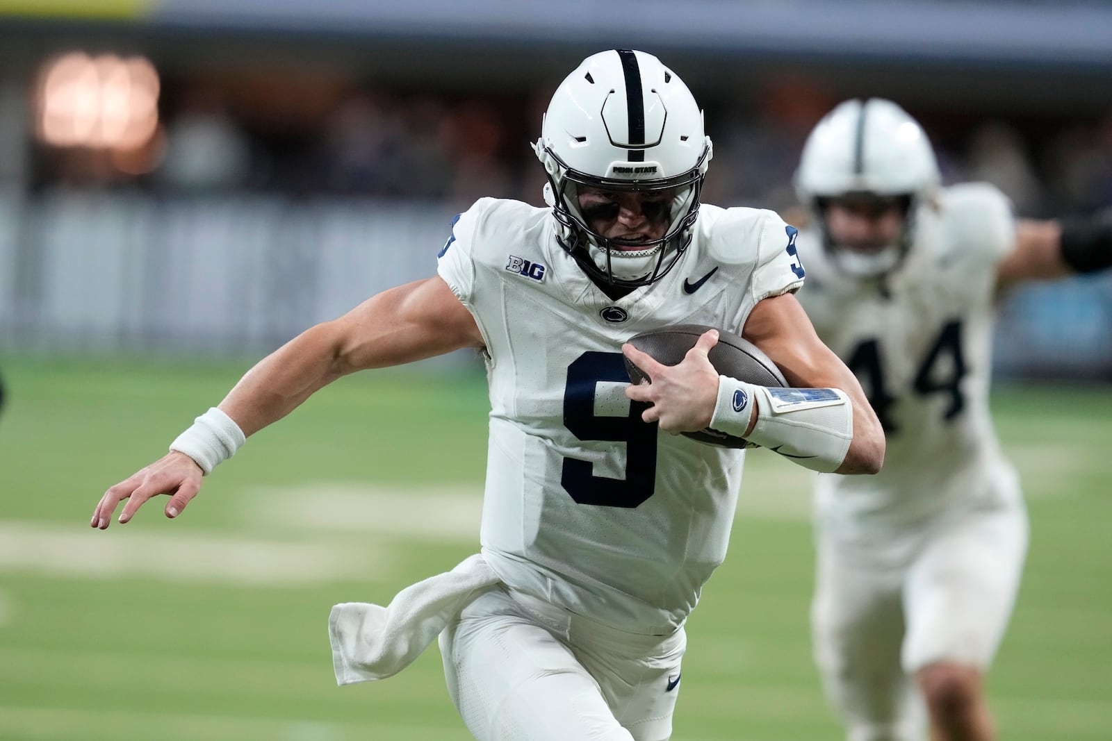 Penn State quarterback Beau Pribula (9) runs up field during the second half of the Big Ten championship NCAA college football game against Oregon, Saturday, Dec. 7, 2024, in Indianapolis. (AP Photo/Darron Cummings)