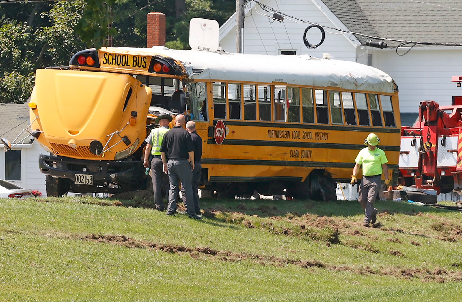 A Northwestern School District bus is uprighted by a crane after it was involved in a crash with another vehicle and rolled over. Twenty three children were transported to the hospital after the crash and one child was killed when they were ejected. BILL LACKEY/STAFF