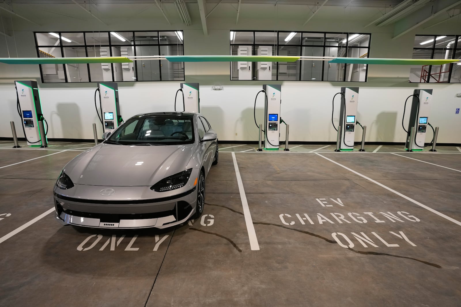 FILE - Charging bays are seen at the new Electrify America indoor electric vehicle charging station in San Francisco, Wednesday, Feb. 7, 2024. (AP Photo/Eric Risberg, File)