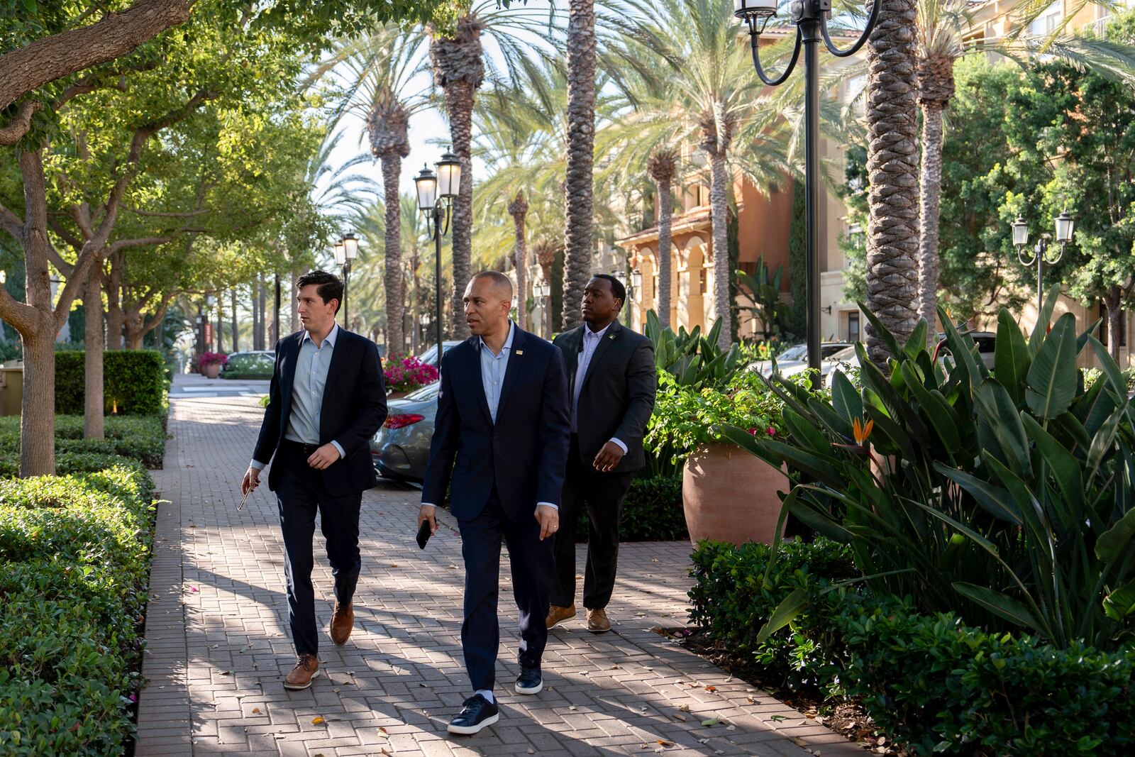 House Minority Leader Hakeem Jeffries, D-N.Y., center, arrives for an interview with The Associated Press, Saturday, Oct. 12, 2024, in Irvine, Calif. (AP Photo/Julia Demaree Nikhinson)