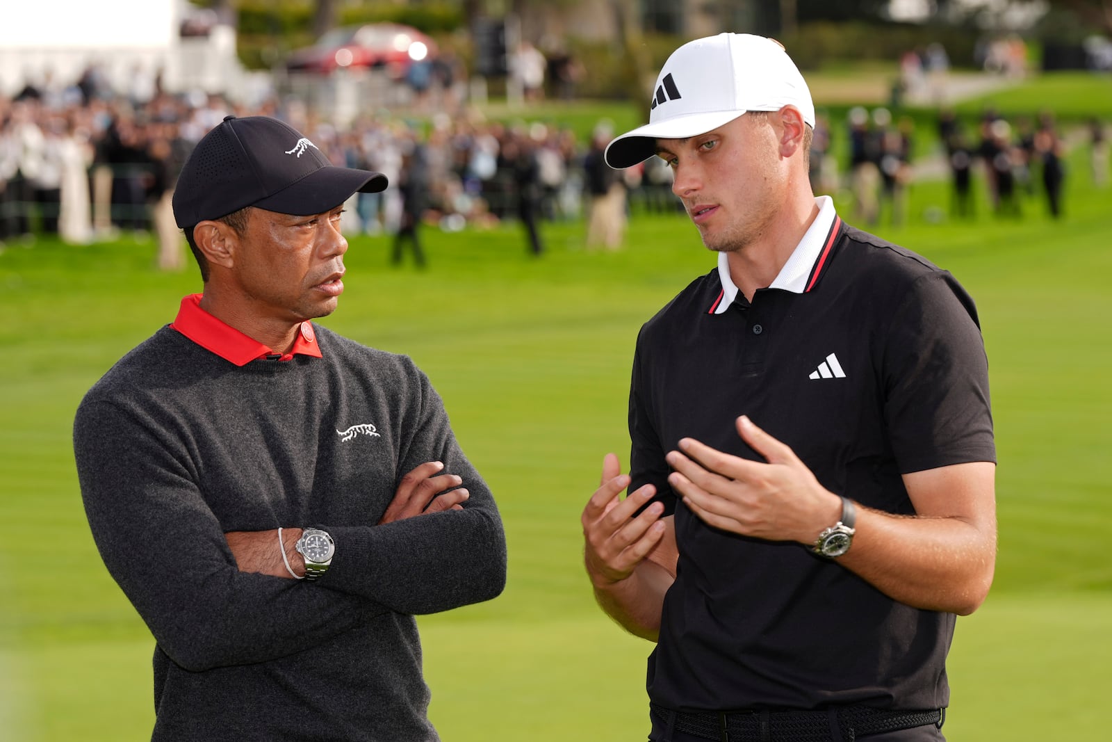 Ludvig Åberg, of Sweden, right, speaks with Tiger Woods after winning the Genesis Invitational golf tournament Sunday, Feb. 16, 2025, in San Diego. (AP Photo/Gregory Bull)