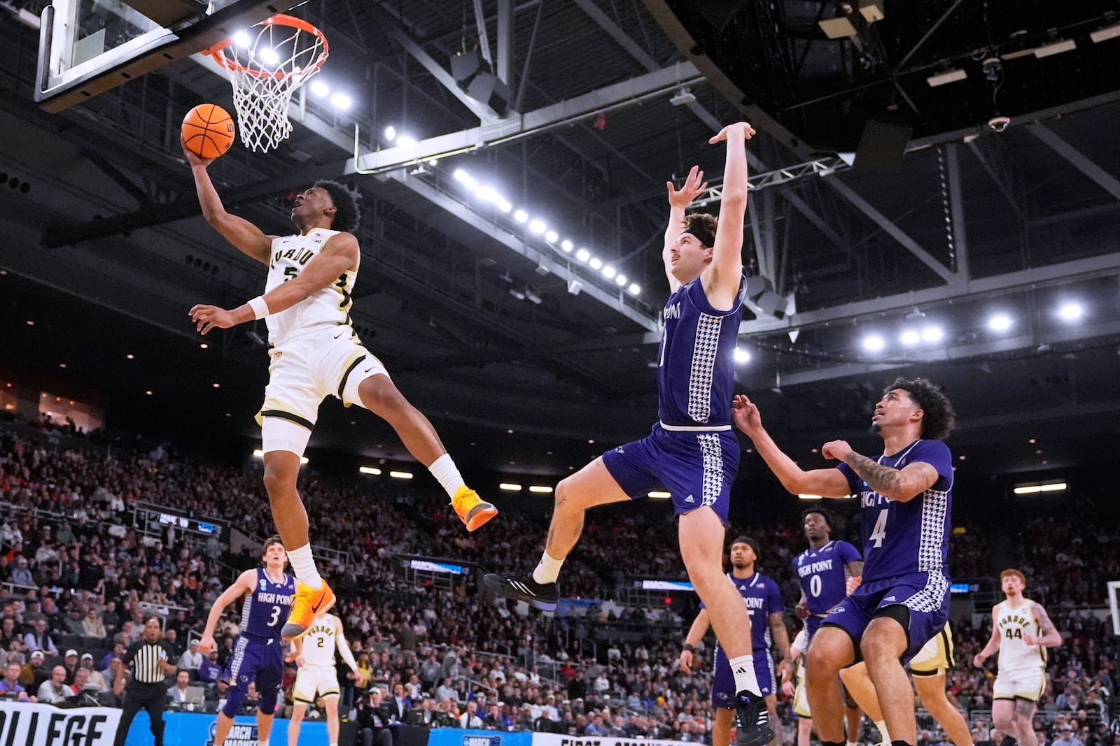 Purdue guard Myles Colvin (5) drives to the basket against High Point during the first half in the first round of the NCAA college basketball tournament, Thursday, March 20, 2025, in Providence, R.I. (AP Photo/Charles Krupa)