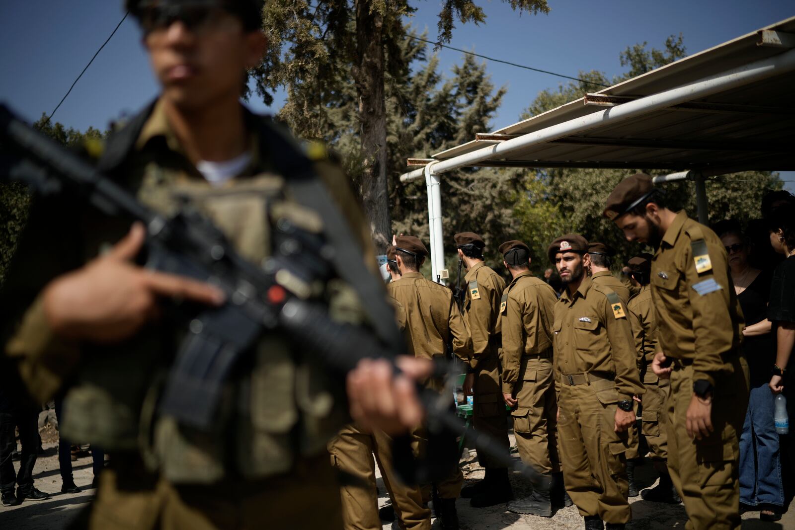 Israeli soldiers mourn Sgt. Yosef Hieb, killed Sunday by a Hezbollah drone attack that wounded dozens and killed four soldiers, while at his funeral in Tuba Zangariyye, Israel, Monday, Oct. 14, 2024. (AP Photo/Leo Correa)