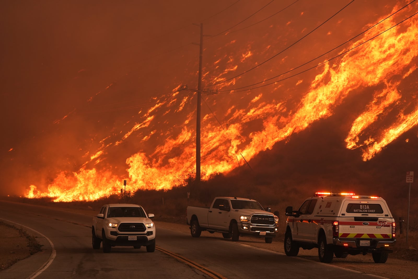 Fighter fighters monitor flames caused by the Hughes Fire along Castaic Lake in Castaic, Calif., Wednesday, Jan. 22, 2025. (AP Photo/Marcio Jose Sanchez)