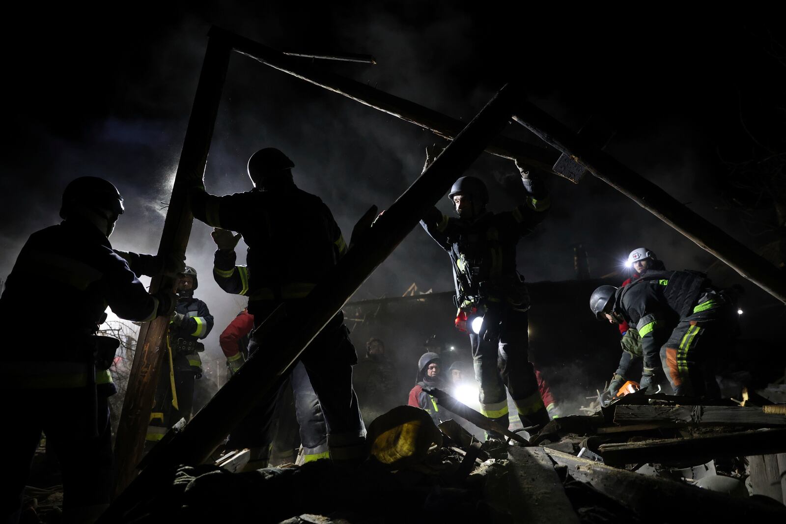 Rescue workers clear the rubble of a residential house destroyed by a Russian drone strike in Zaporizhzhia, Ukraine, March 21, 2024. (AP Photo/Kateryna Klochko)