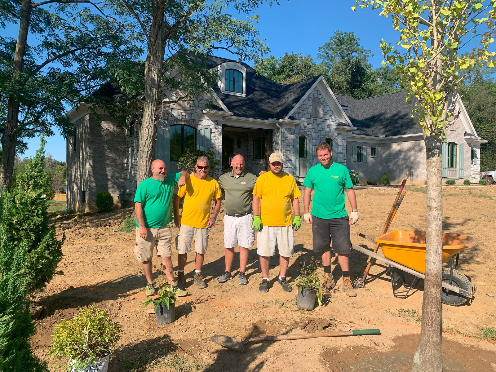 The landscaping crew from Gold-n-Touch Landscaping with owner-president Skip Coleman finish working on the lot prior to move-in day. Coleman is a graduate of Stebbins High School.