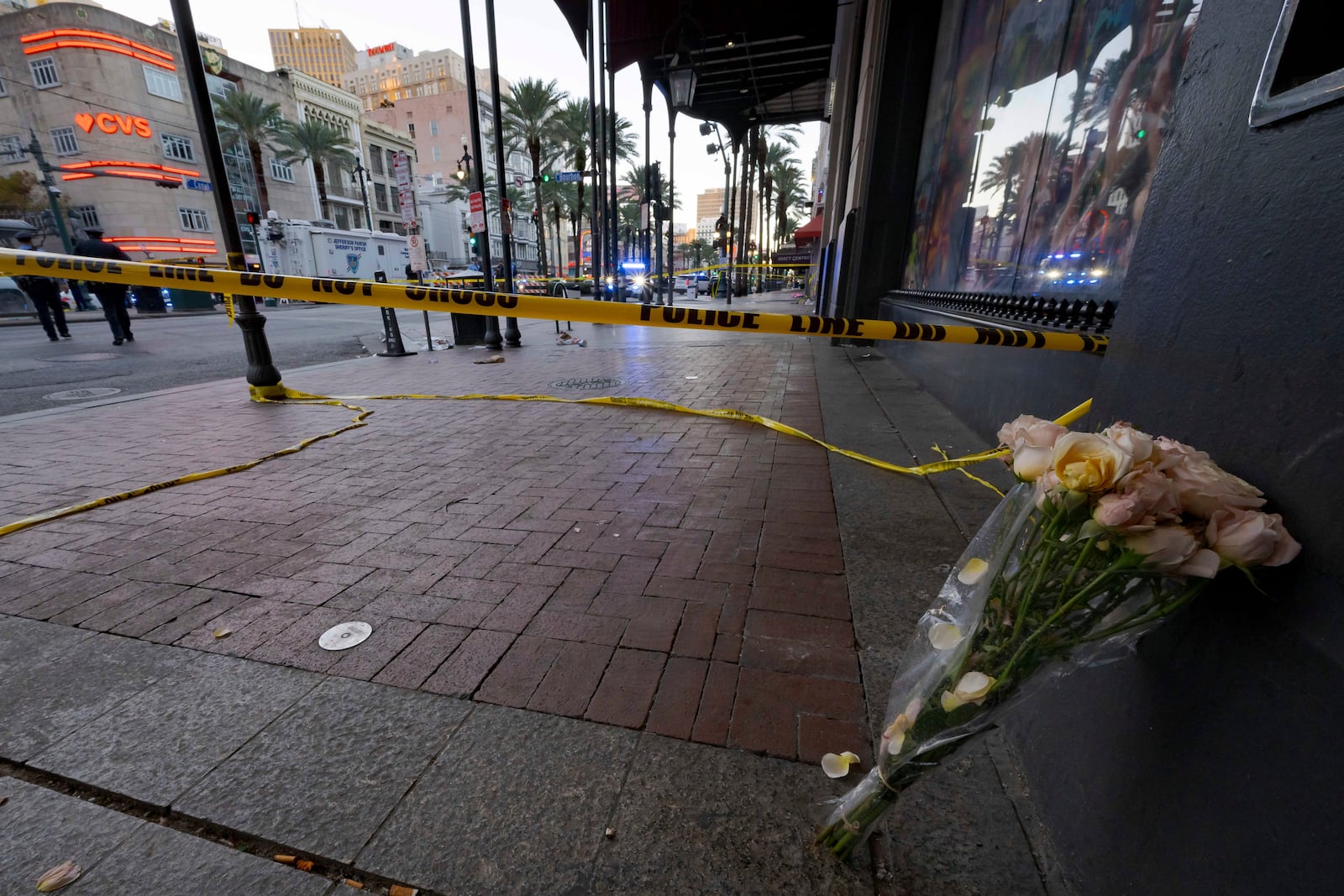 A bouquet of flowers stands at the intersection of Bourbon Street and Canal Street during the investigation after a pickup truck rammed into a crowd of revelers early on New Year's Day, Wednesday, Jan. 1, 2025, in New Orleans. (AP Photo/Matthew Hinton)