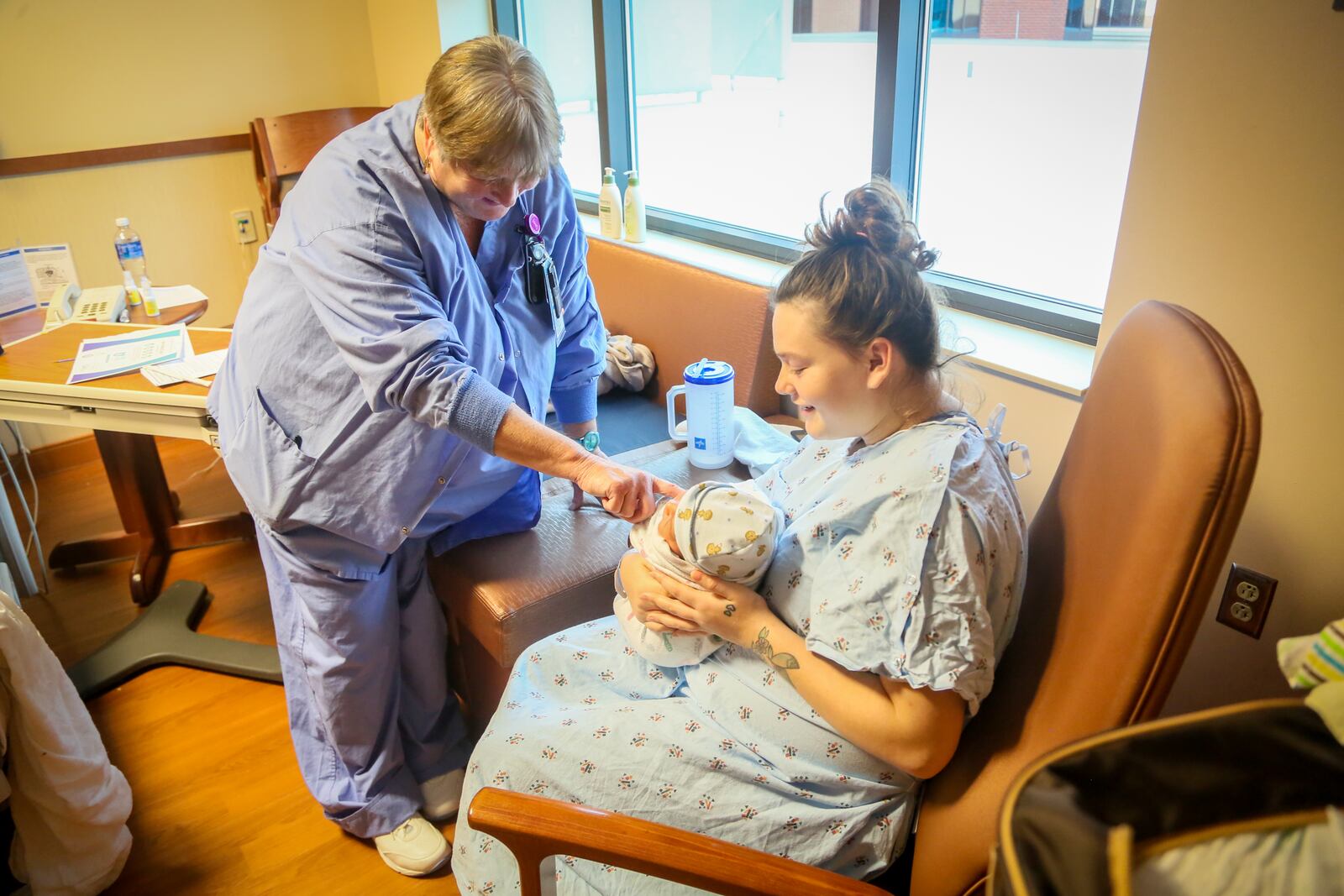 Tracy Justice, Lactation Consultant, Atrium Medical Center, talks with new mother, Barbara Jones, Monday, Nov. 21, 2016. At Atrium Medical Center, about 60 percent of mothers now breastfeed exclusively. Atrium has earned a 5 Star rating from the Ohio Department of Health and the Ohio Hospital Association for completing the 10 steps advocated by the Ohio First Steps for Healthy Babies program. GREG LYNCH / STAFF