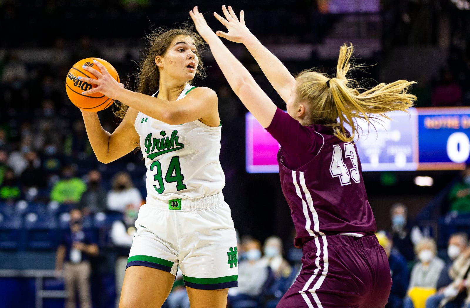 Notre Dame's Maddy Westbeld (34) looks to pass as Fordham's Megan Jonassen (43) defends during an NCAA college basketball game, Thursday, Nov. 18, 2021, at Purcell Pavilion in South Bend, Ind. (Michael Caterina/South Bend Tribune via AP)