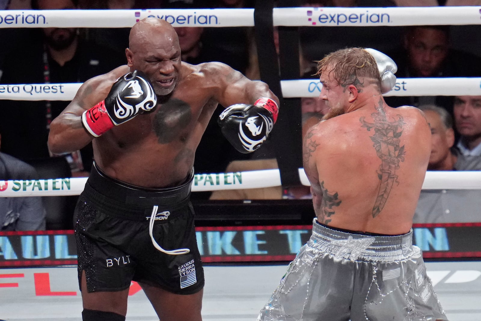 Mike Tyson, left, fights Jake Paul during their heavyweight boxing match, Friday, Nov. 15, 2024, in Arlington, Texas. (AP Photo/Julio Cortez)