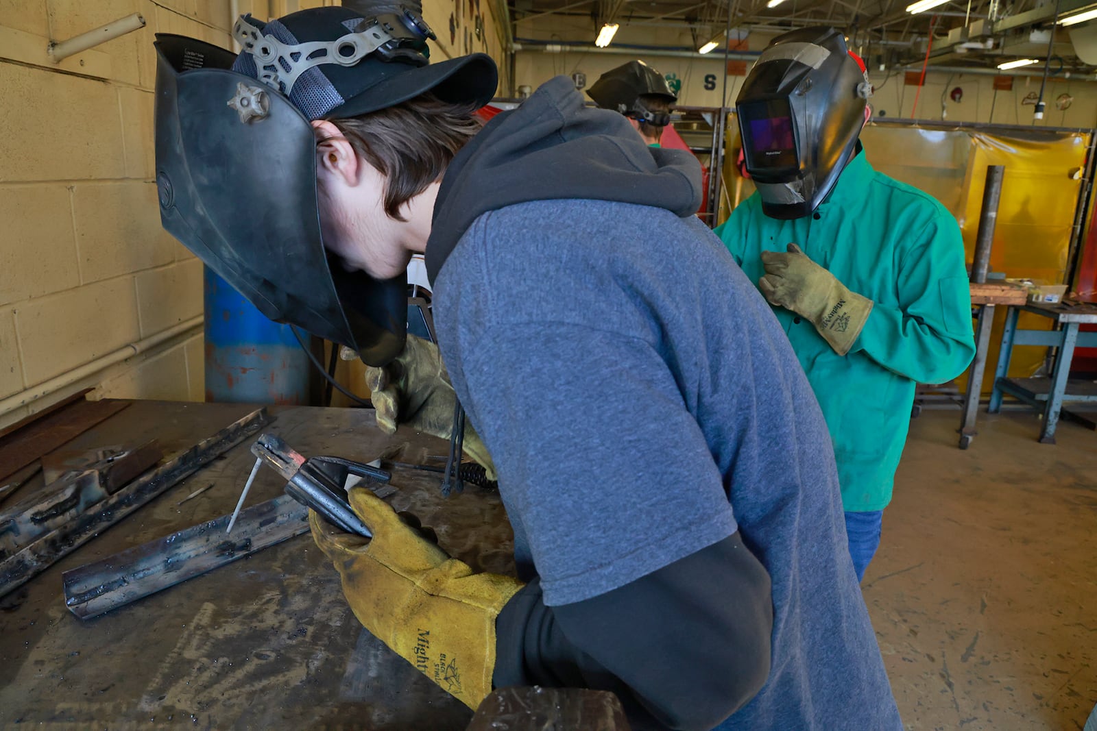 Aydon Budd, senior,  Northeastern High School, and Chris Williams, senior, Tecumseh High School, practice welding in the Applied Engineering & Manufacturing program at CTC Friday, Oct. 18, 2024. BILL LACKEY/STAFF