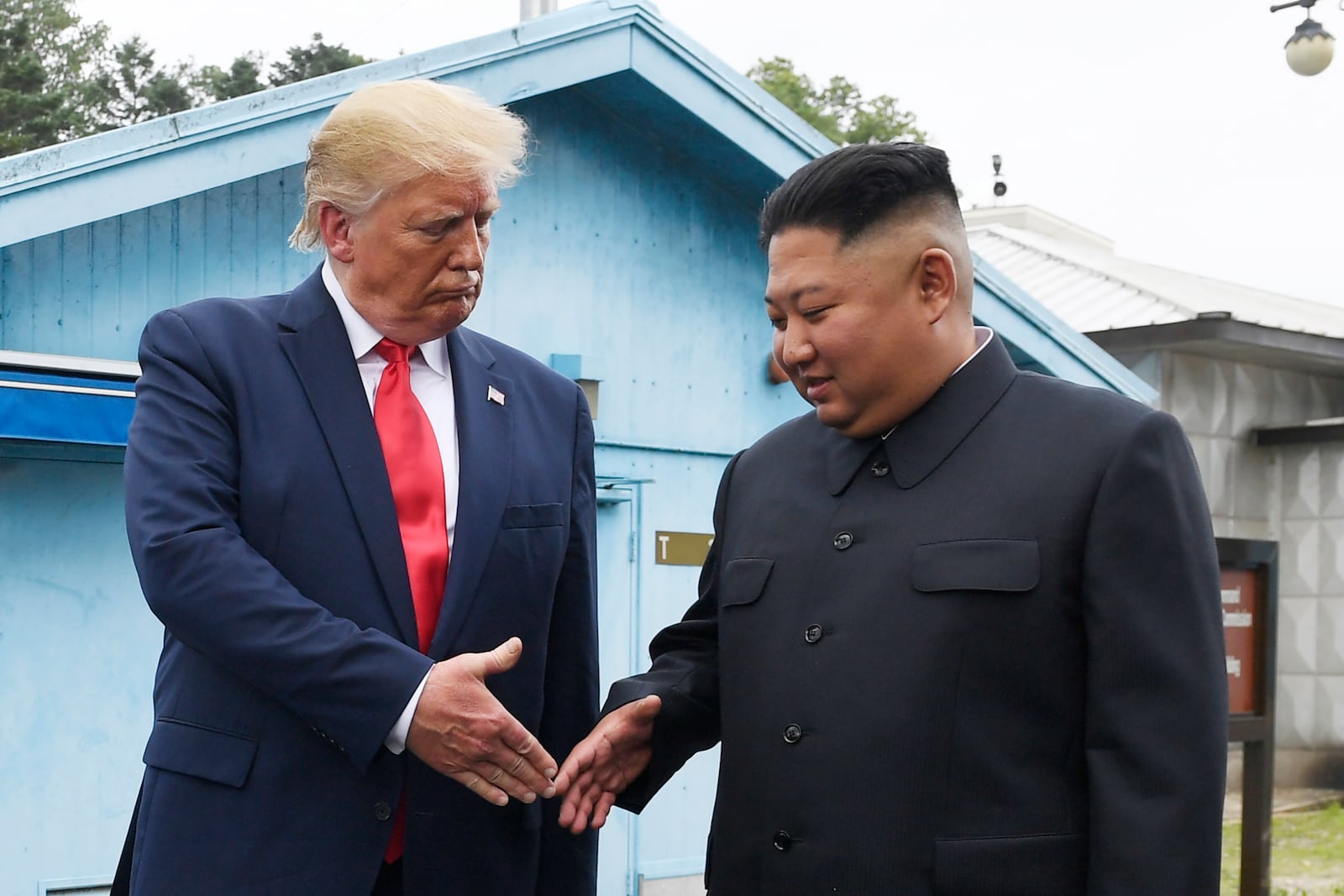 FILE - North Korean leader Kim Jong Un, right, and U.S. President Donald Trump shake hands at the border village of Panmunjom in the Demilitarized Zone on June 30, 2019. (AP Photo/Susan Walsh, File)