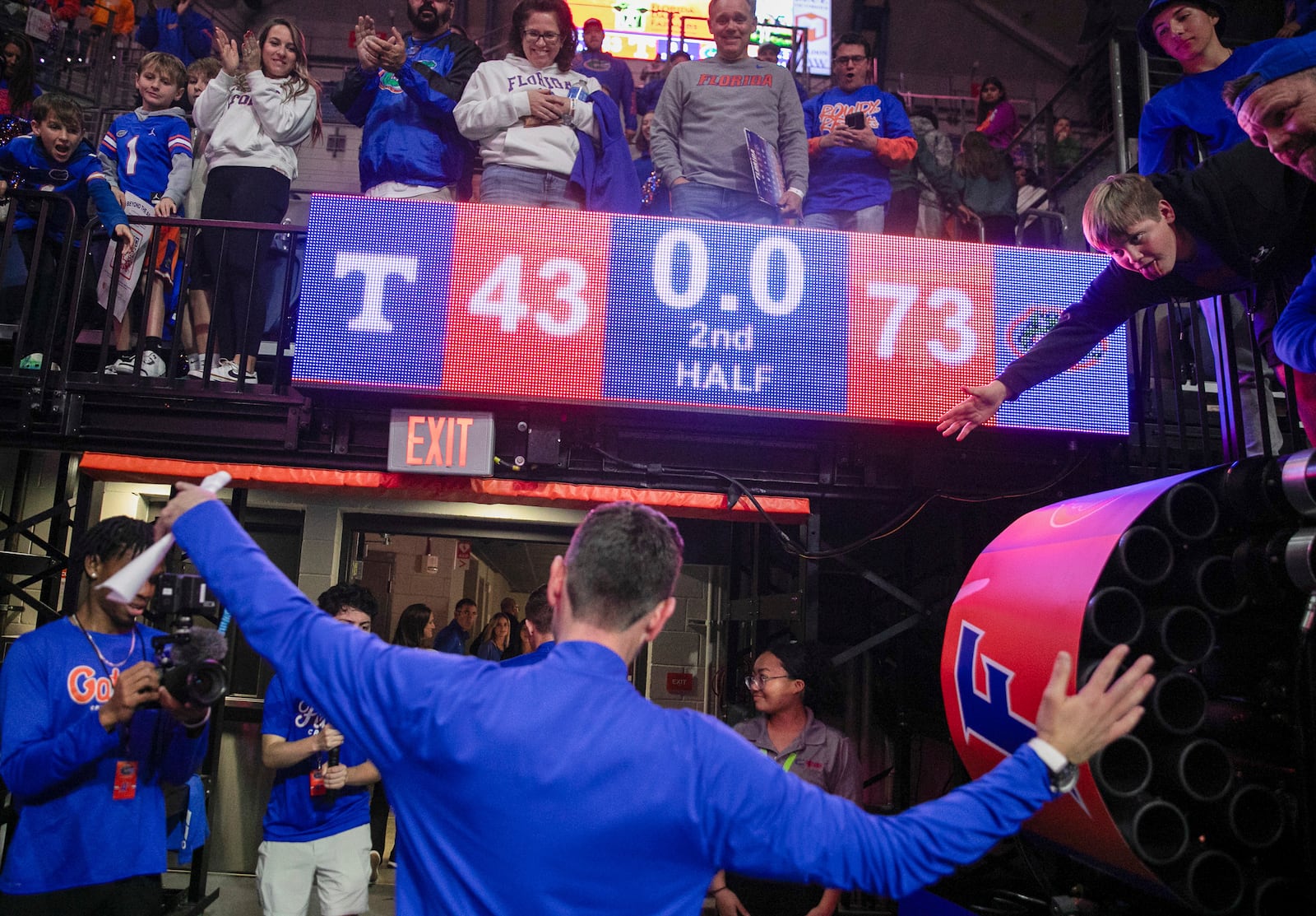 Florida head coach Todd Golden celebrates with fan after defeating Tennessee 73-43 in an NCAA college basketball game Tuesday, Jan. 7, 2025, in Gainesville, Fla. (AP Photo/Alan Youngblood)