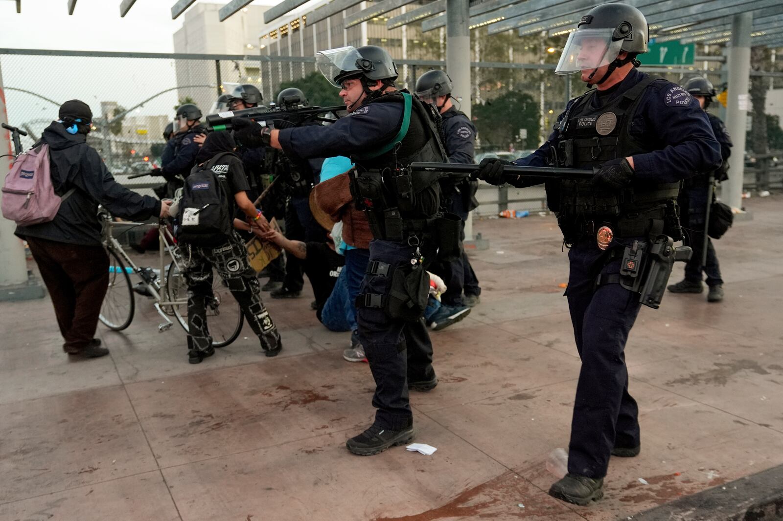 Police face off with demonstrators during an immigrant rights protest Monday, Feb. 3, 2025, in Los Angeles. (AP Photo/Damian Dovarganes)